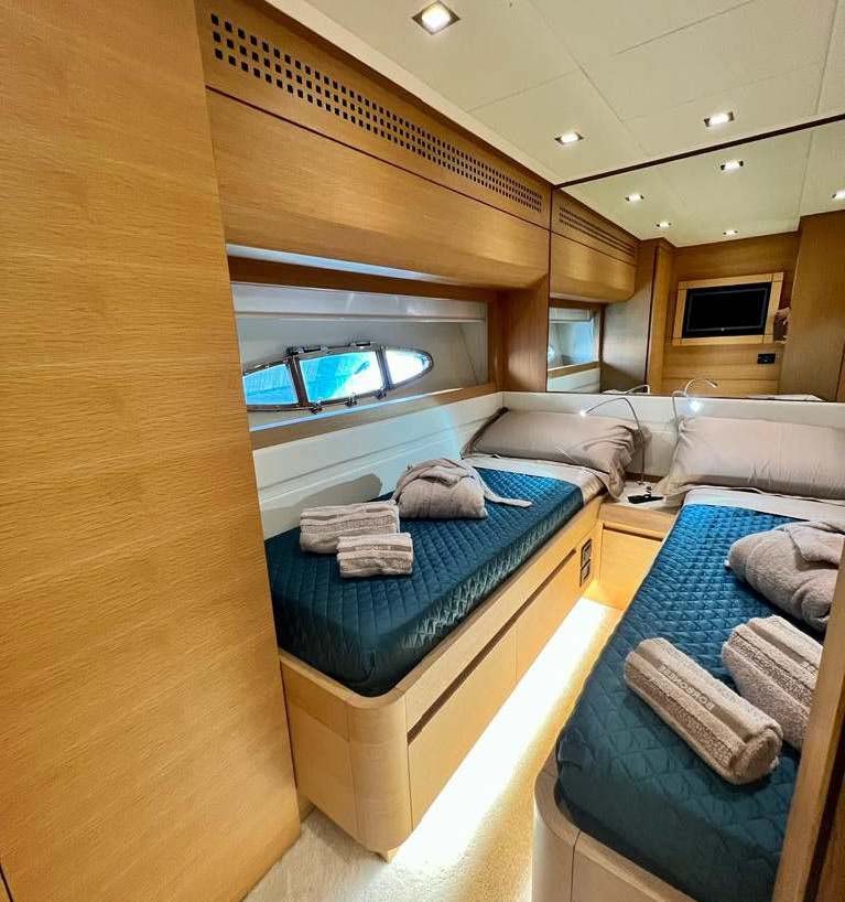 a room with a bed and a couch aboard THYKE II Yacht for Charter