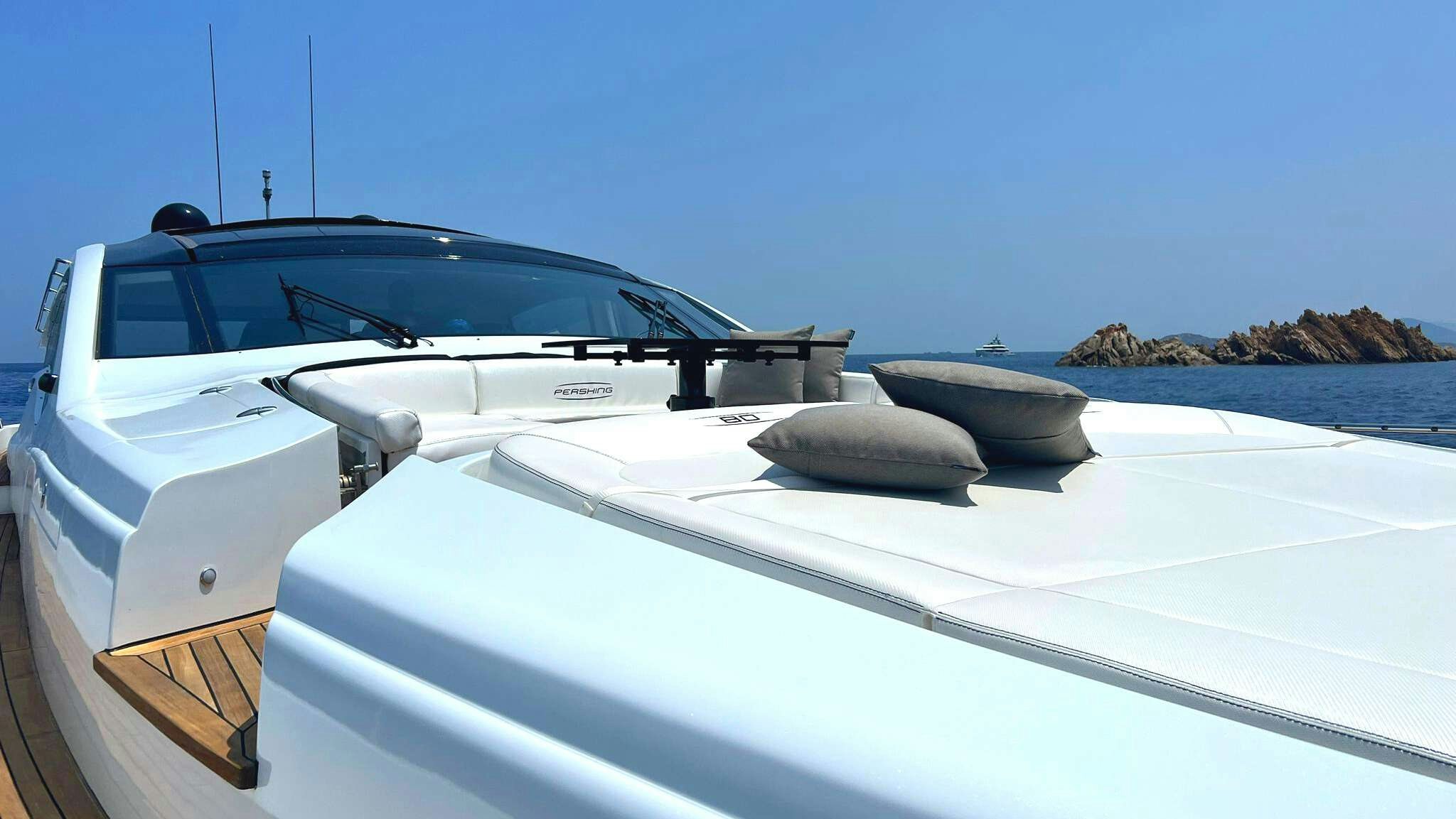 a white boat on a beach aboard THYKE II Yacht for Charter