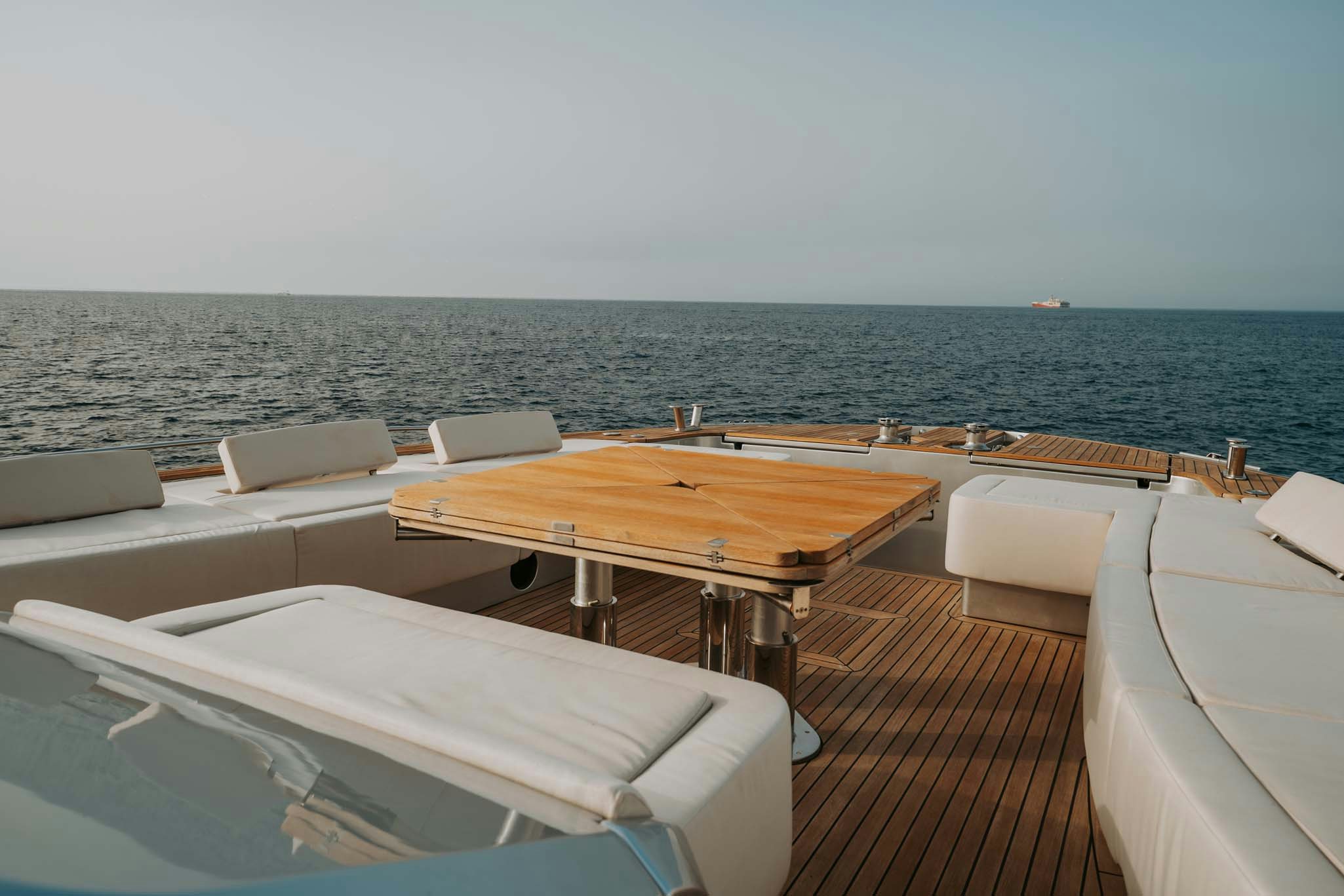 a room with a table and chairs on it by the water aboard VENUS Yacht for Charter