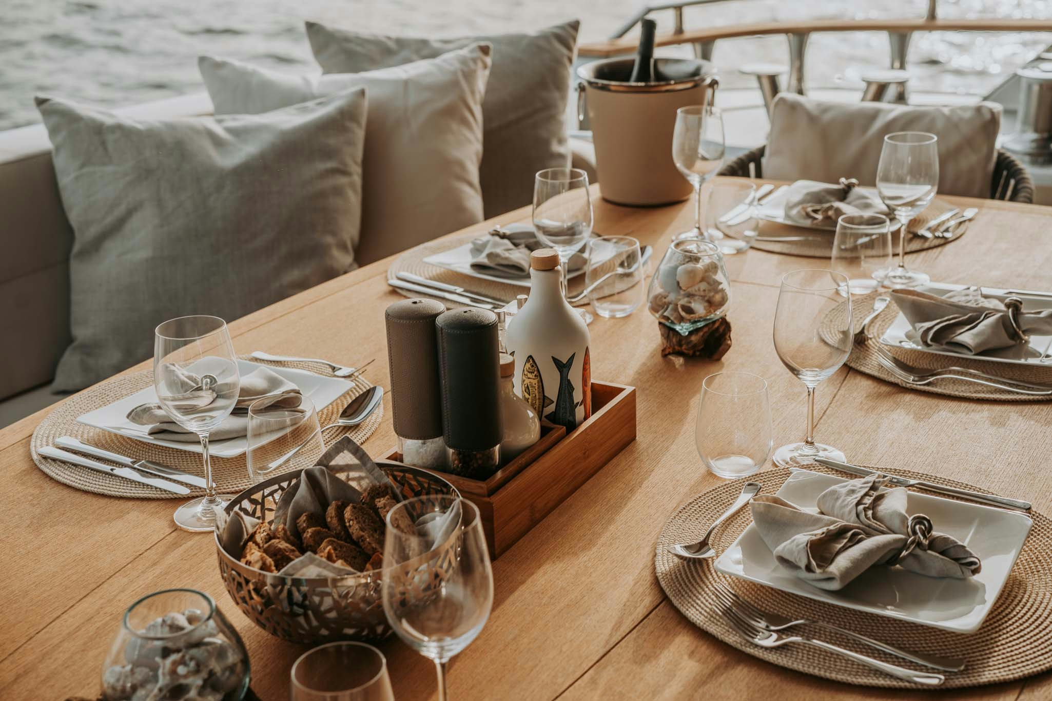 a table with plates and glasses aboard VENUS Yacht for Charter