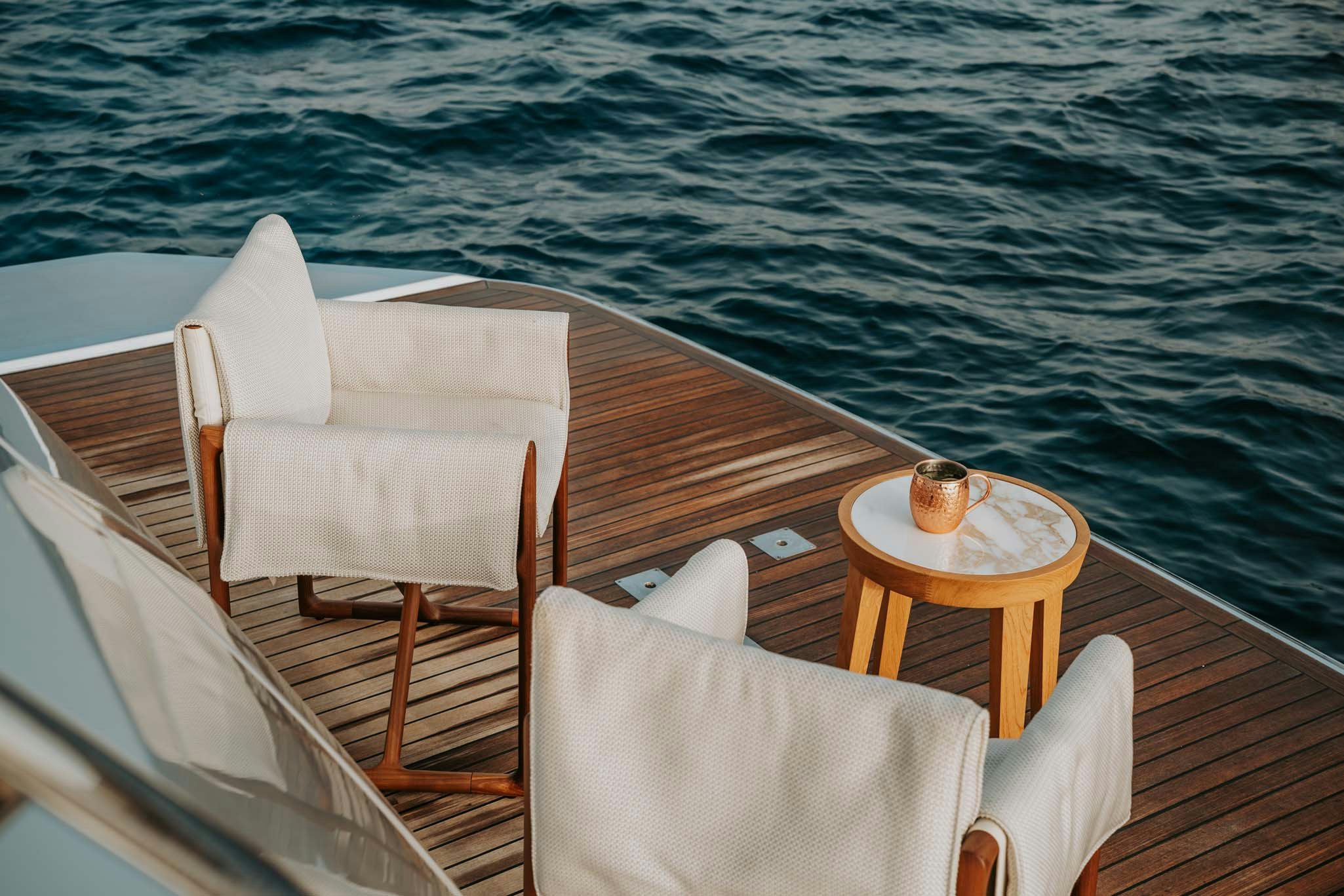 a table and chairs on a boat aboard VENUS Yacht for Charter