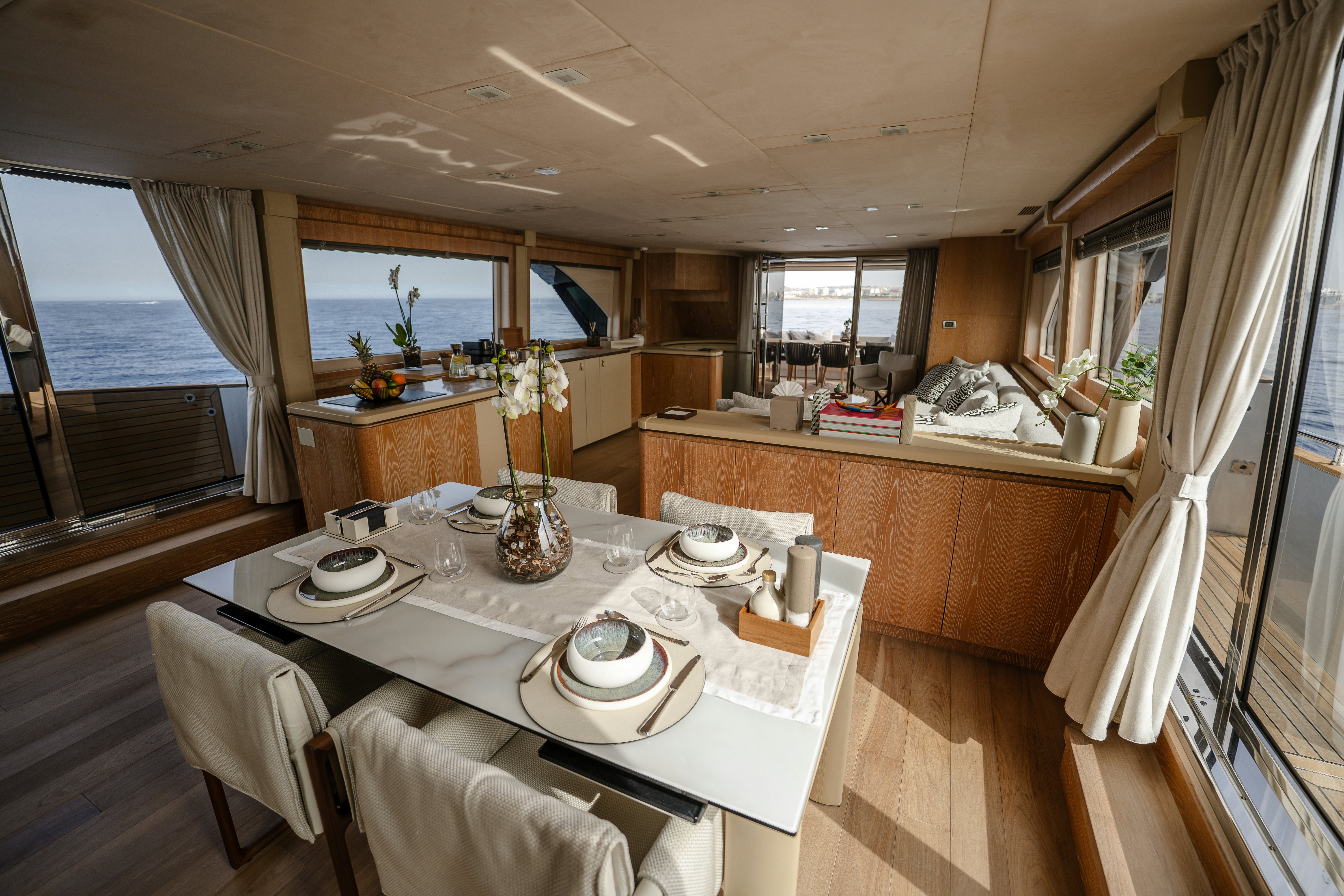 a large kitchen with a dining table aboard VENUS Yacht for Sale