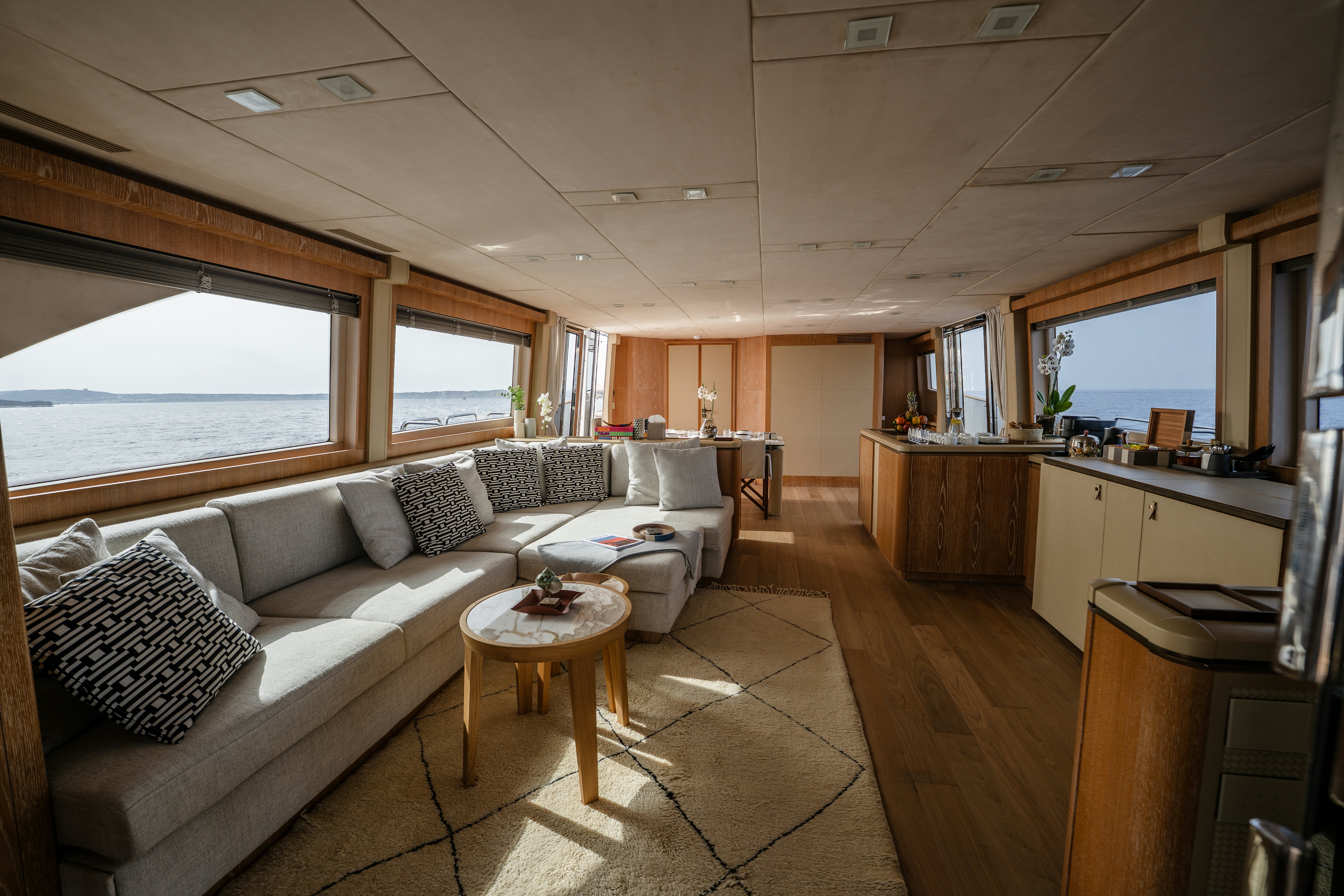 a living room with a couch and a table aboard VENUS Yacht for Sale