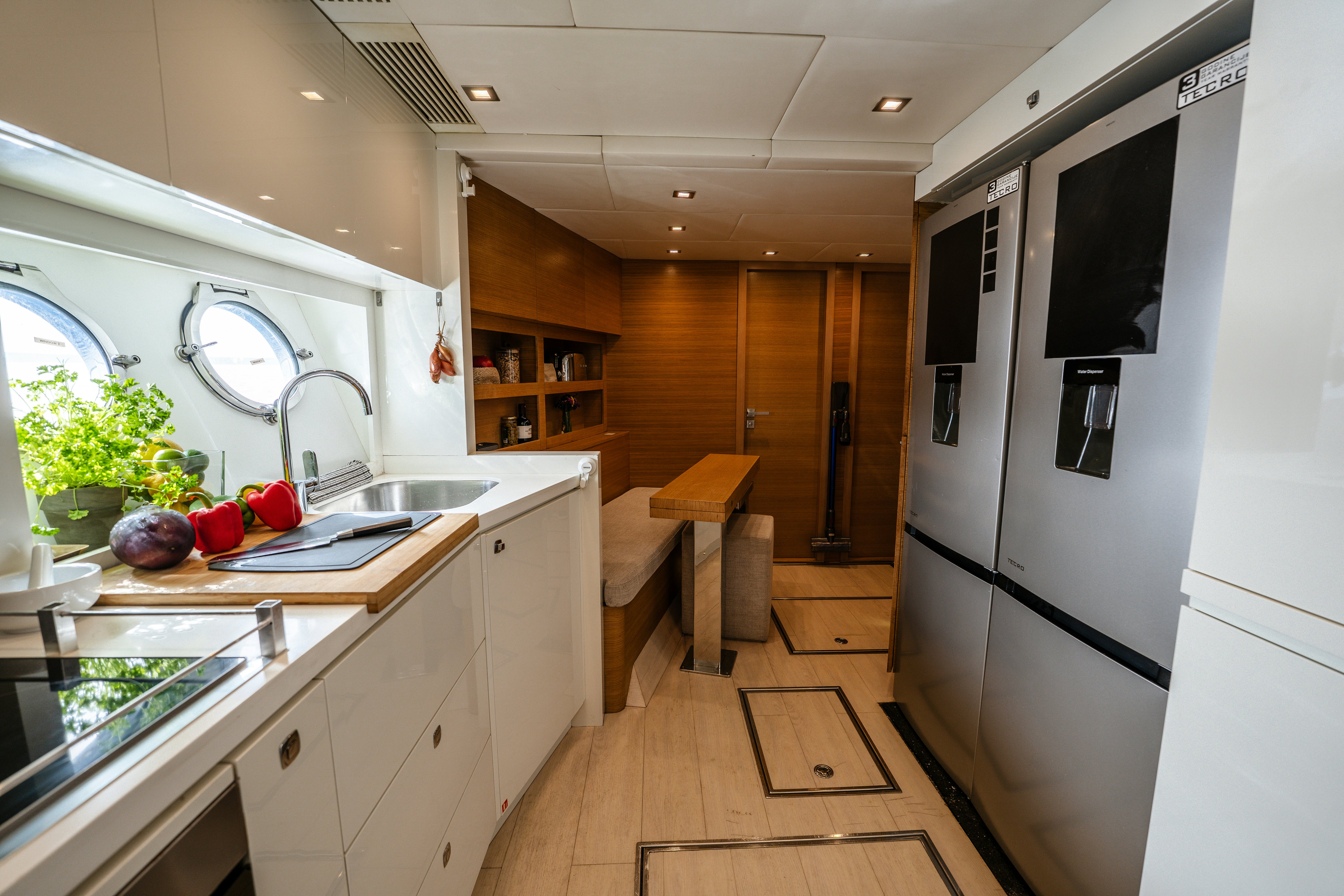 a kitchen with white cabinets aboard VENUS Yacht for Sale