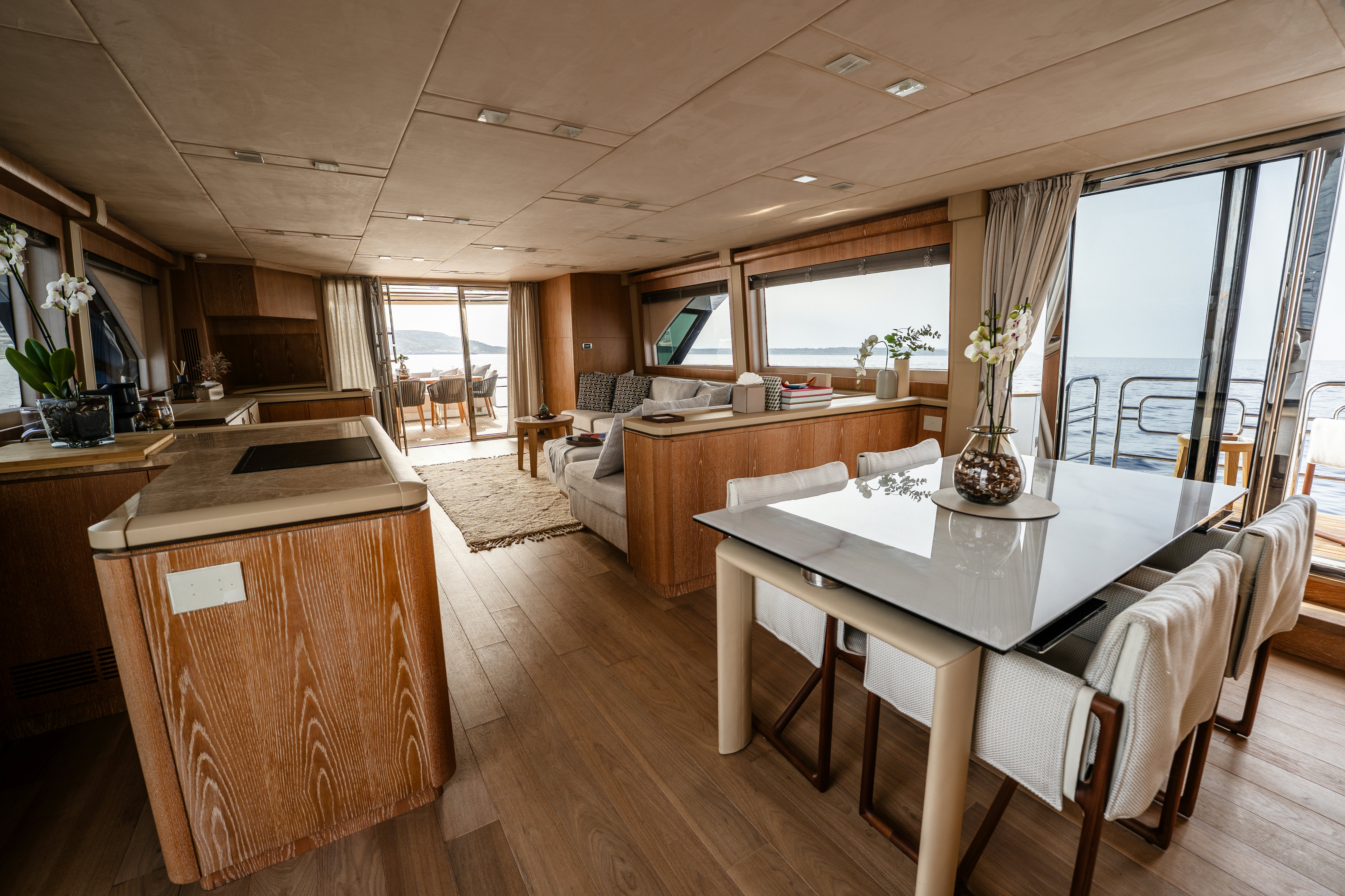 a large kitchen with a table and chairs aboard VENUS Yacht for Sale