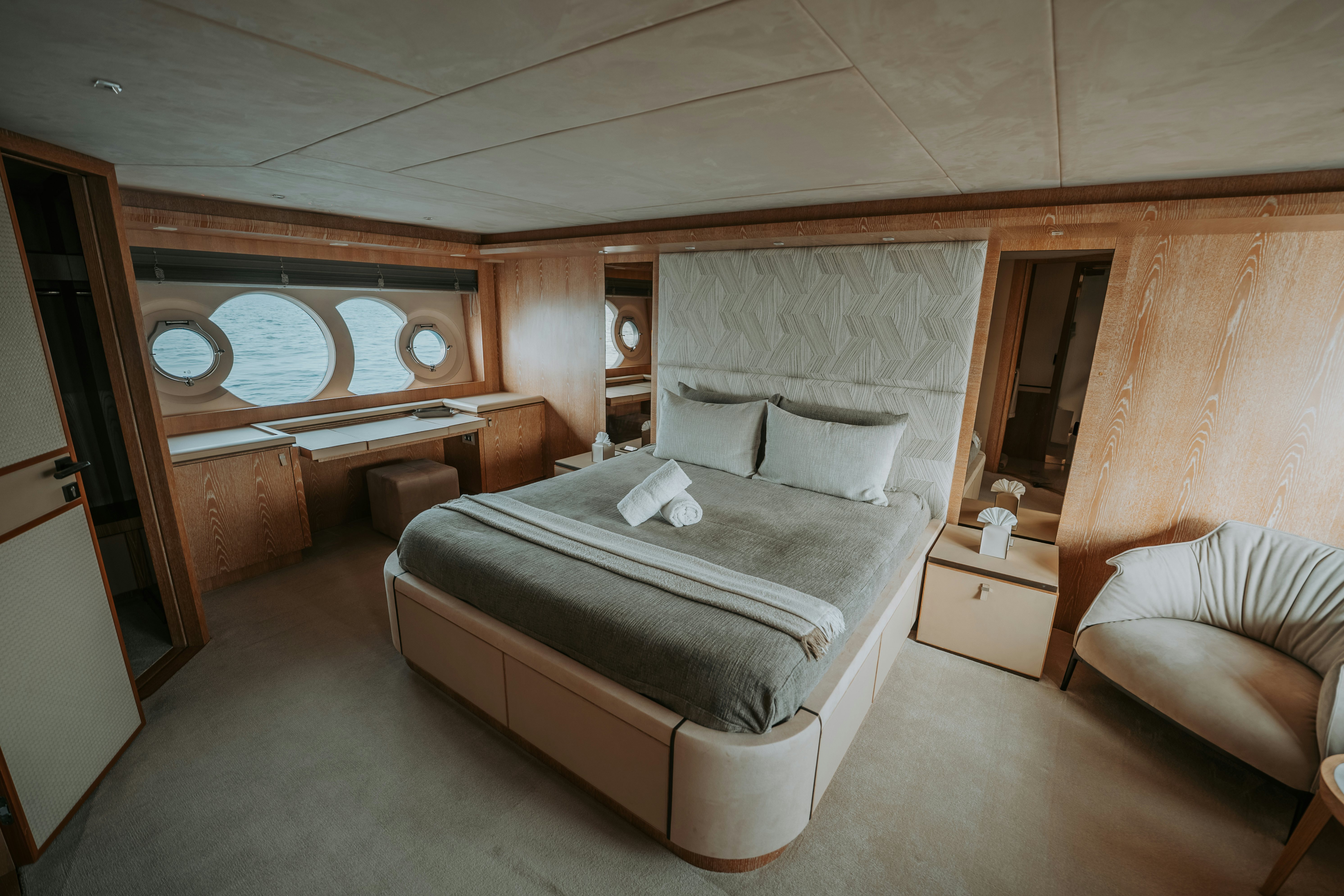 a room with a bed and a couch aboard VENUS Yacht for Sale