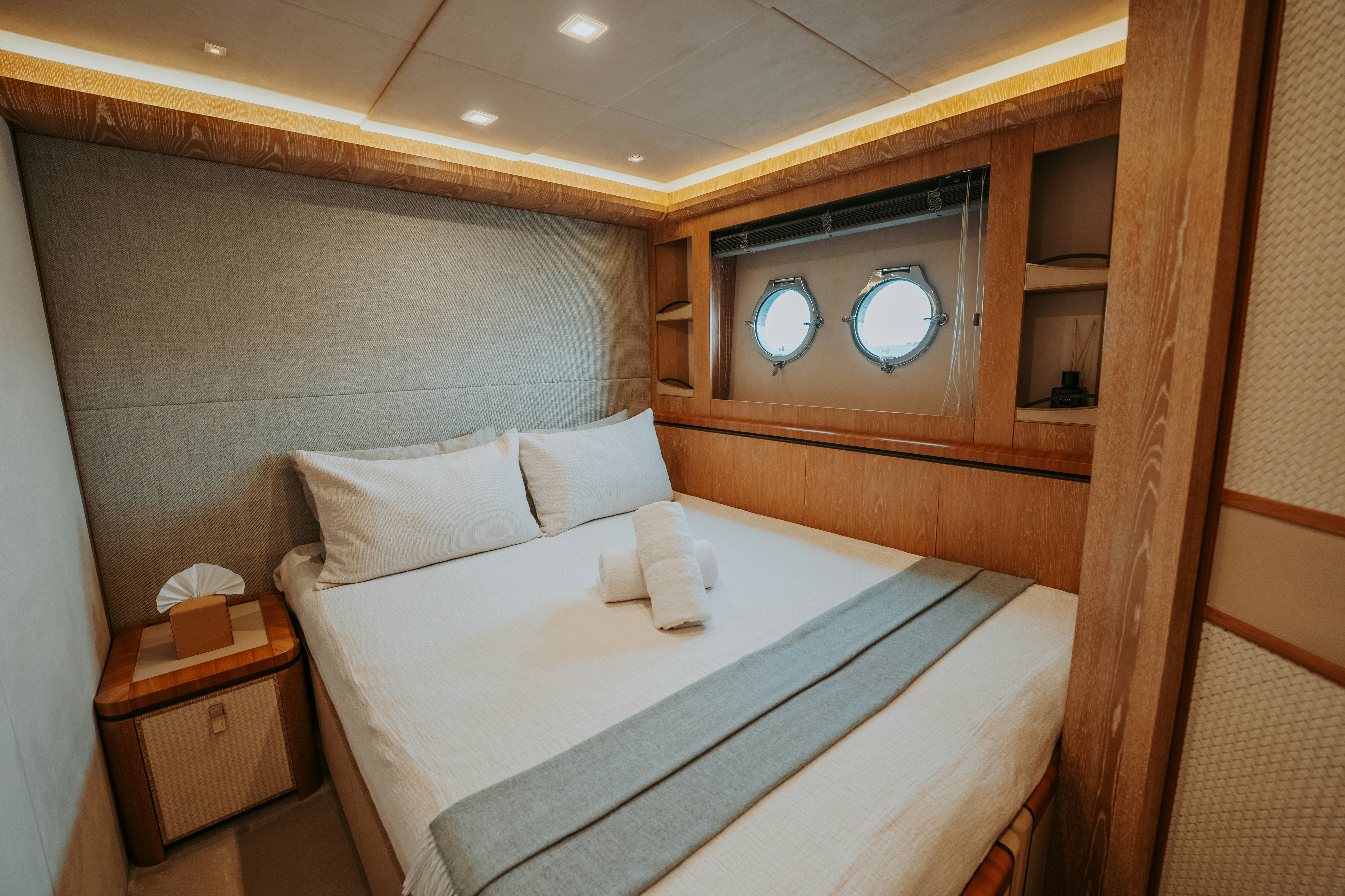 a bed with white sheets aboard VENUS Yacht for Sale