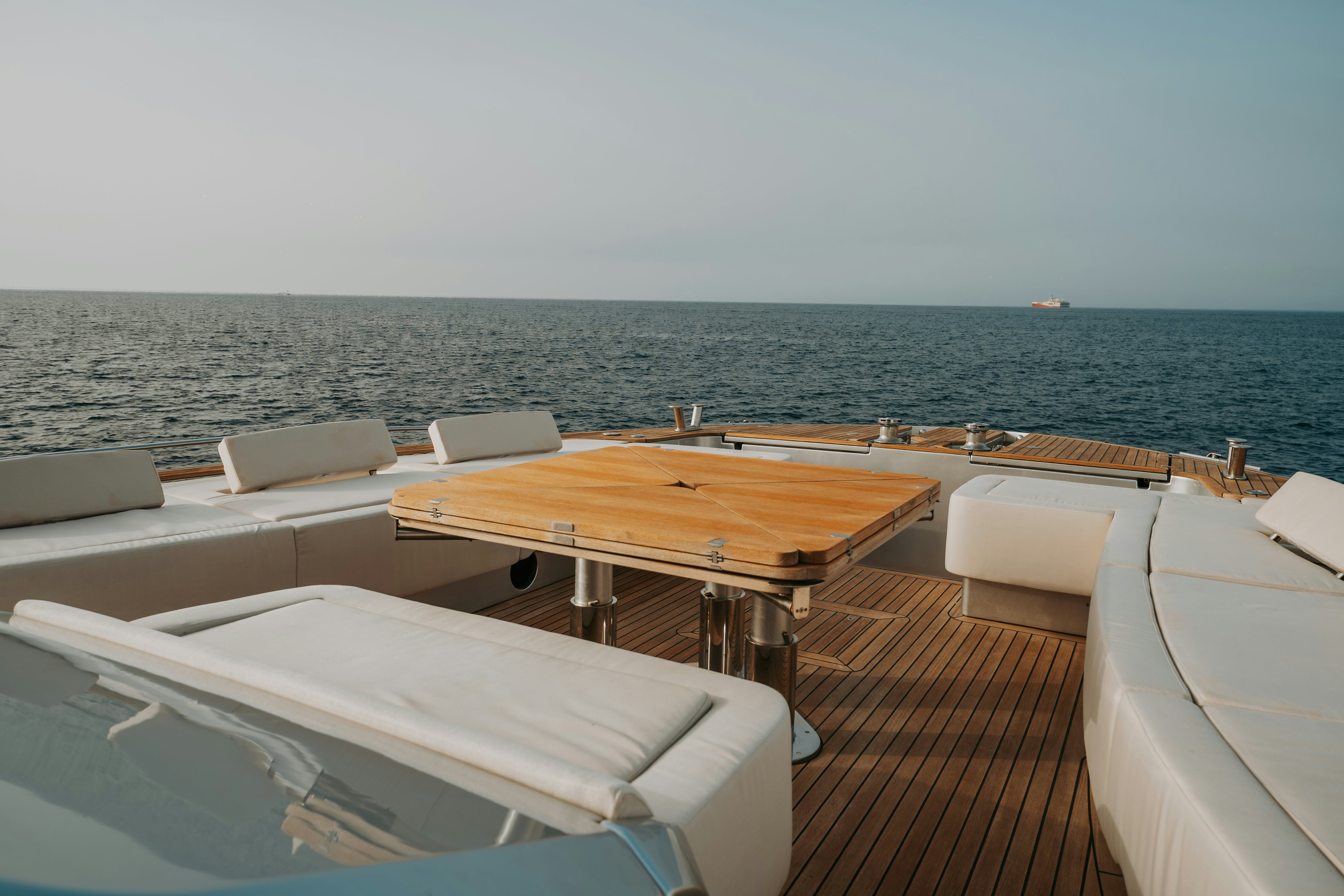 a table and chairs on a deck overlooking the ocean aboard VENUS Yacht for Sale