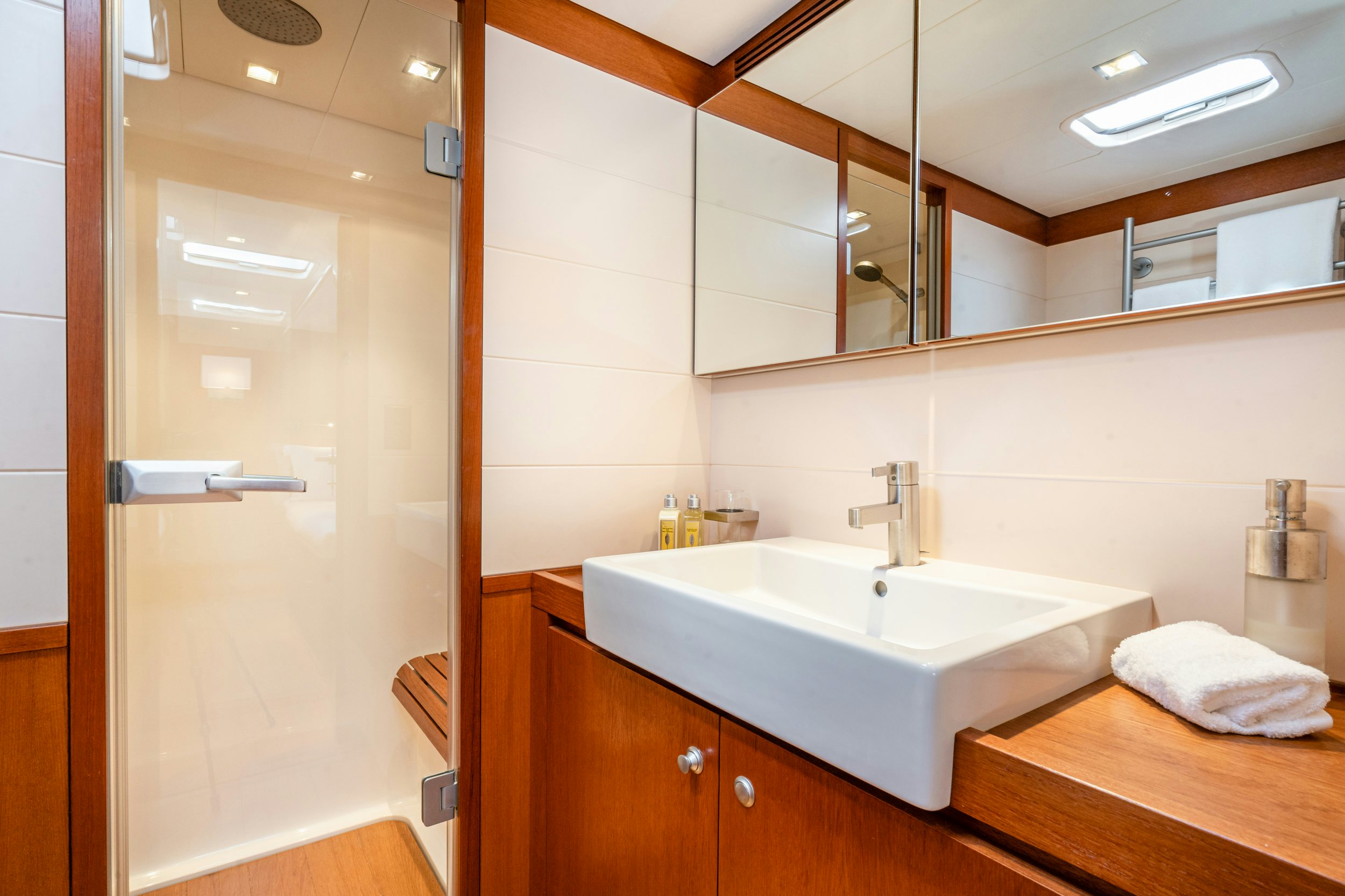 a bathroom with a sink and a mirror aboard SAVUKE Yacht for Sale