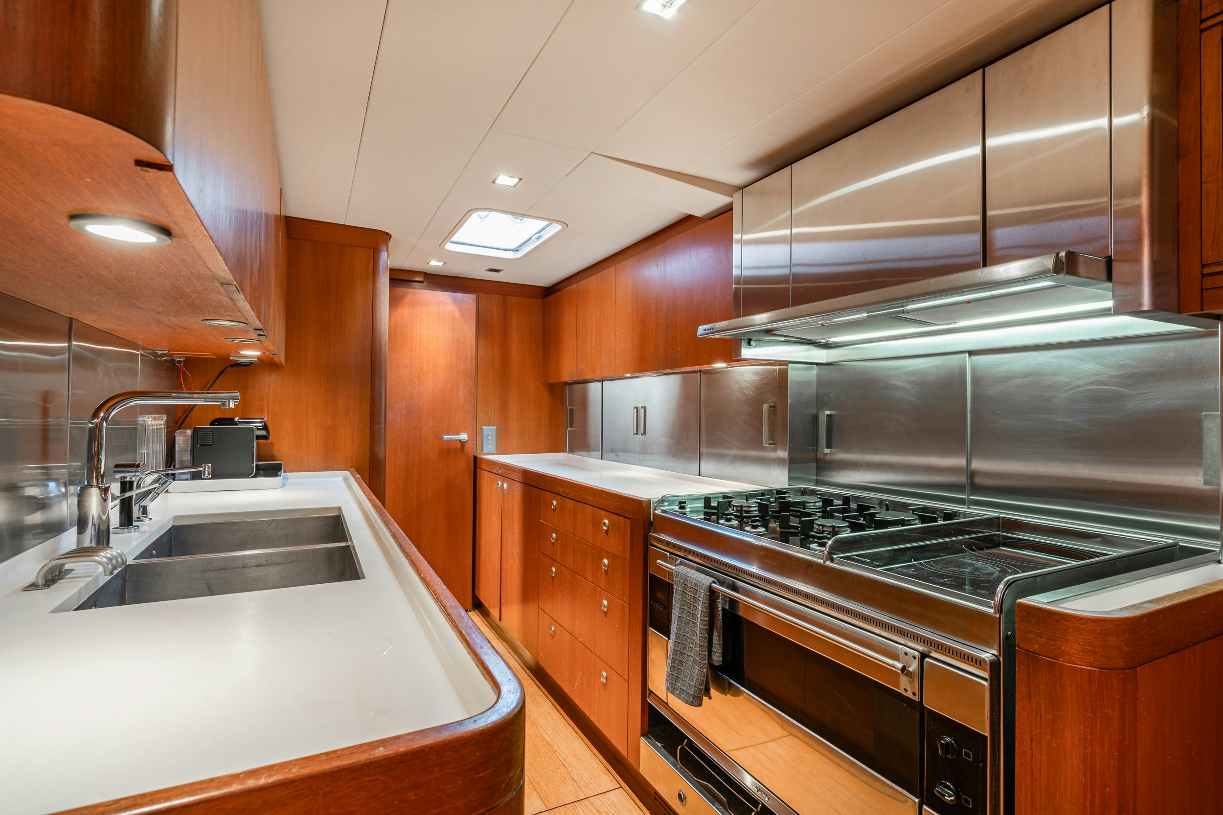 a kitchen with a stainless steel stove aboard SAVUKE Yacht for Sale