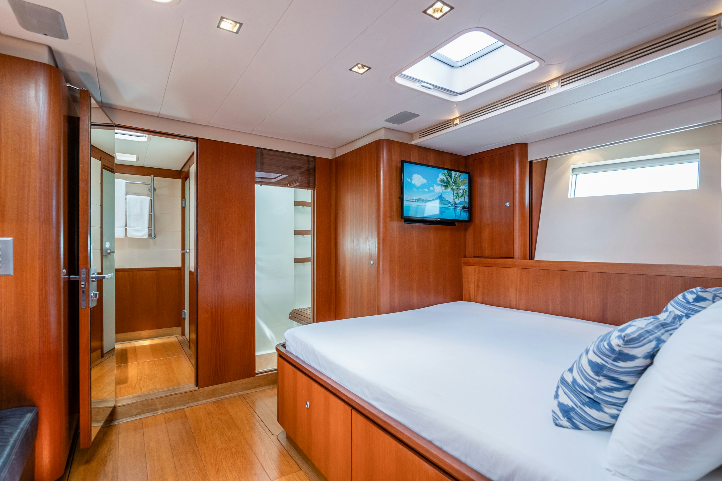 a room with a bed and a tv on the wall aboard SAVUKE Yacht for Sale