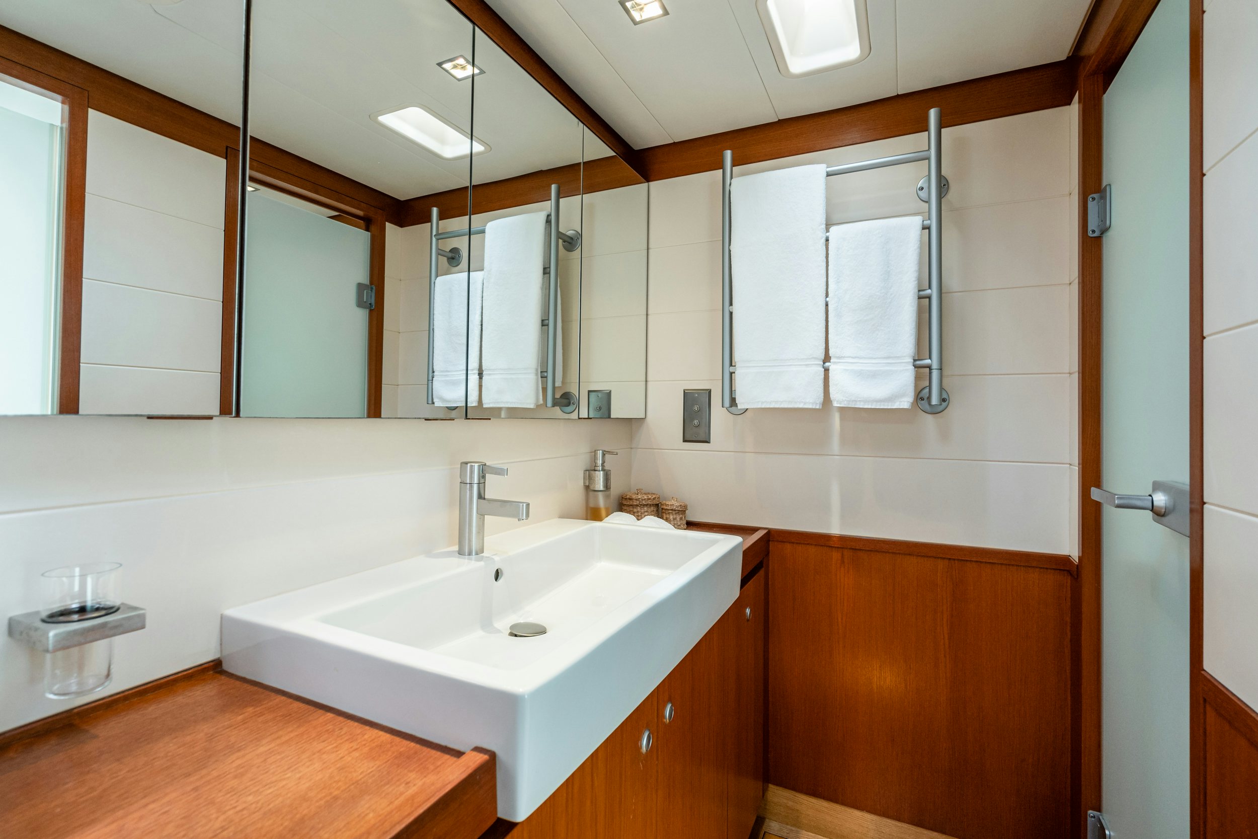 a bathroom with a sink and a mirror aboard SAVUKE Yacht for Sale