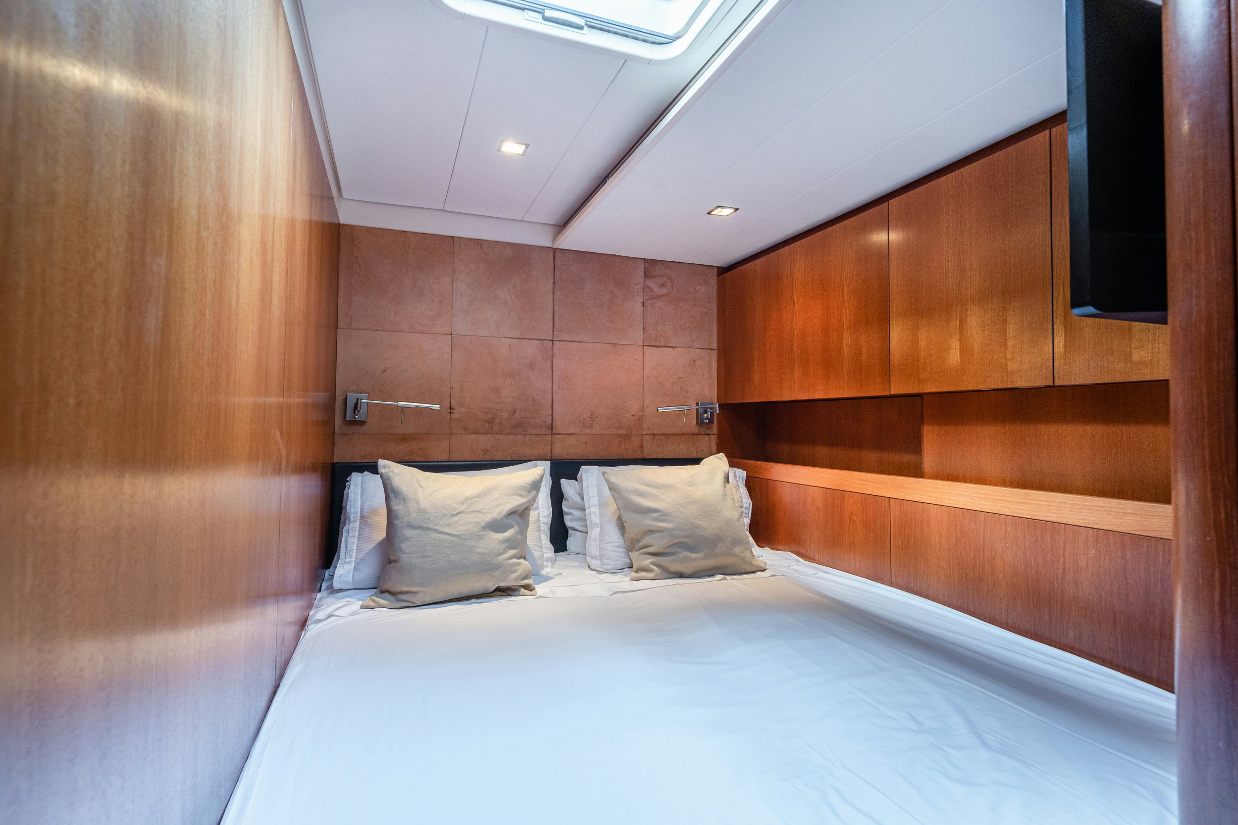 a bed with white sheets aboard SAVUKE Yacht for Sale