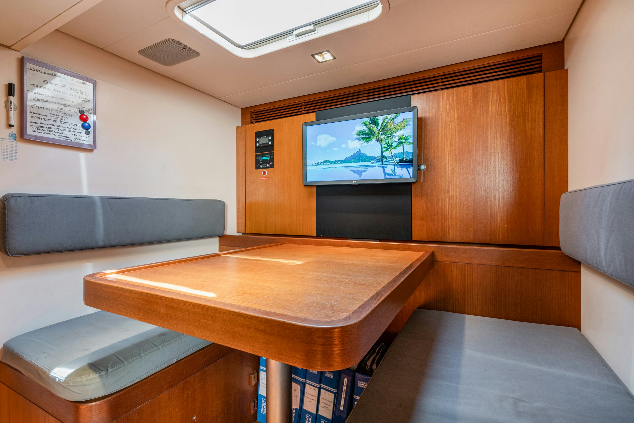 a room with a table and tv aboard SAVUKE Yacht for Sale
