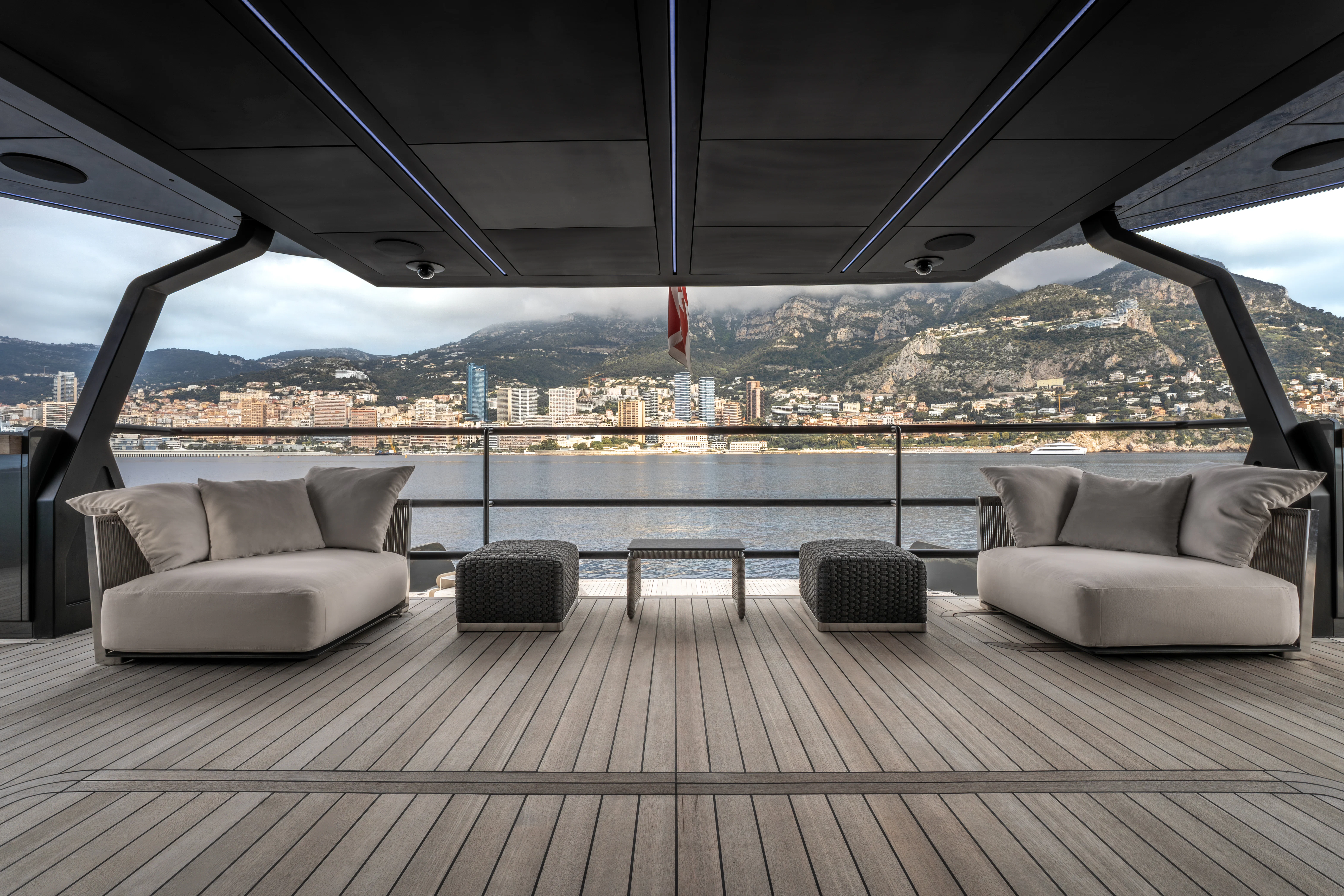 a large room with couches and a flag aboard K+ Yacht for Sale