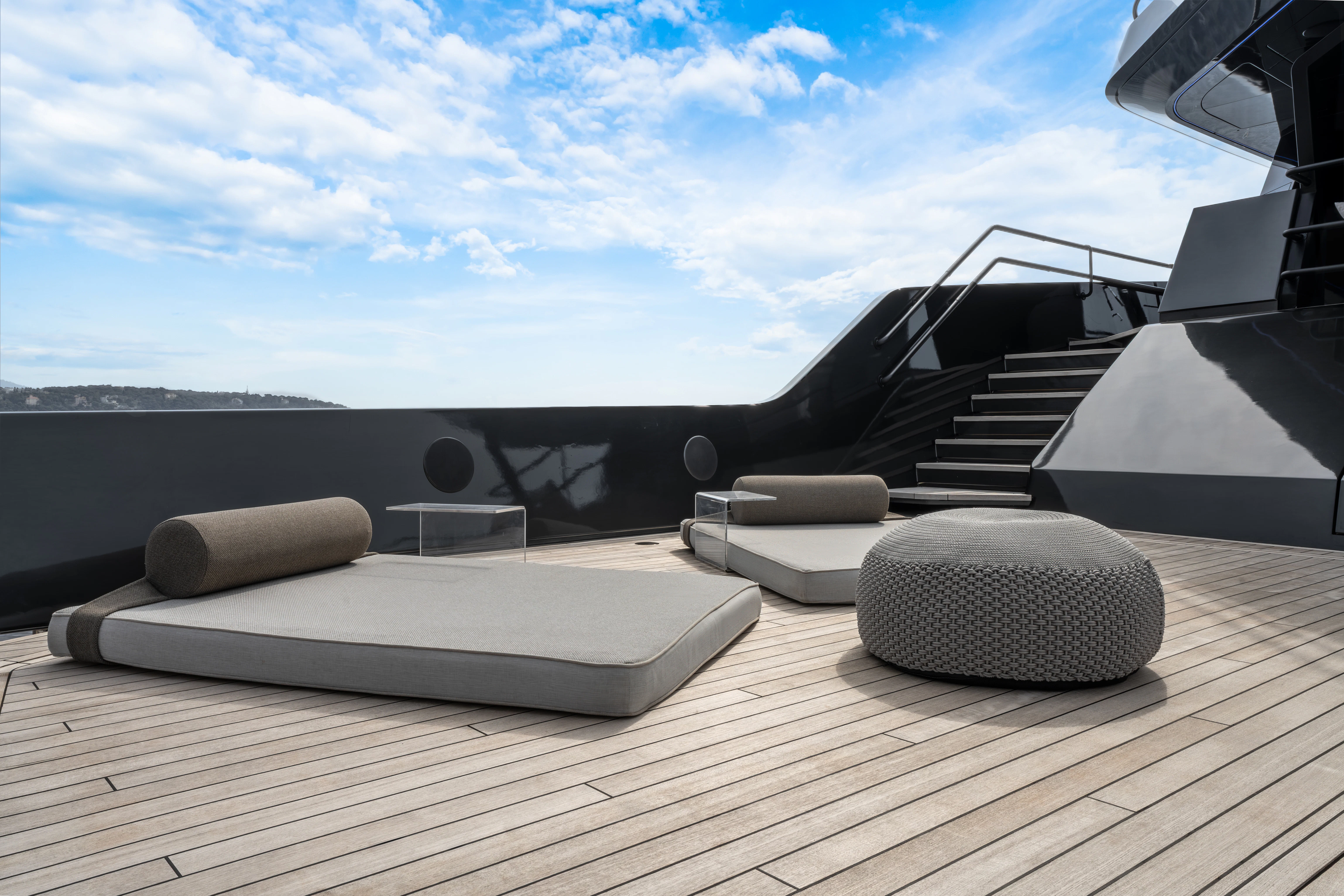 a desk with a laptop and speakers aboard K+ Yacht for Sale