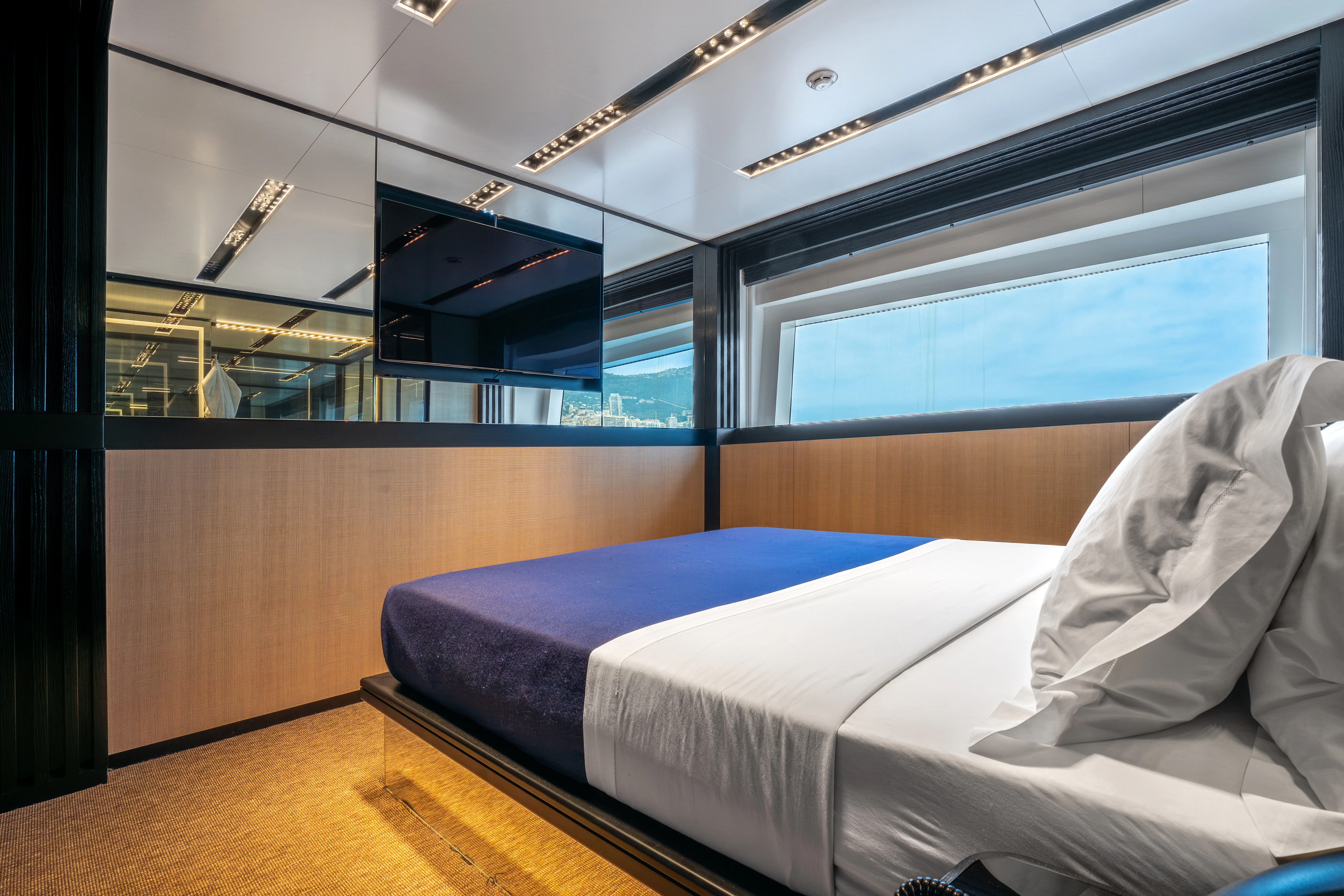 a room with a bed and a window aboard K+ Yacht for Sale