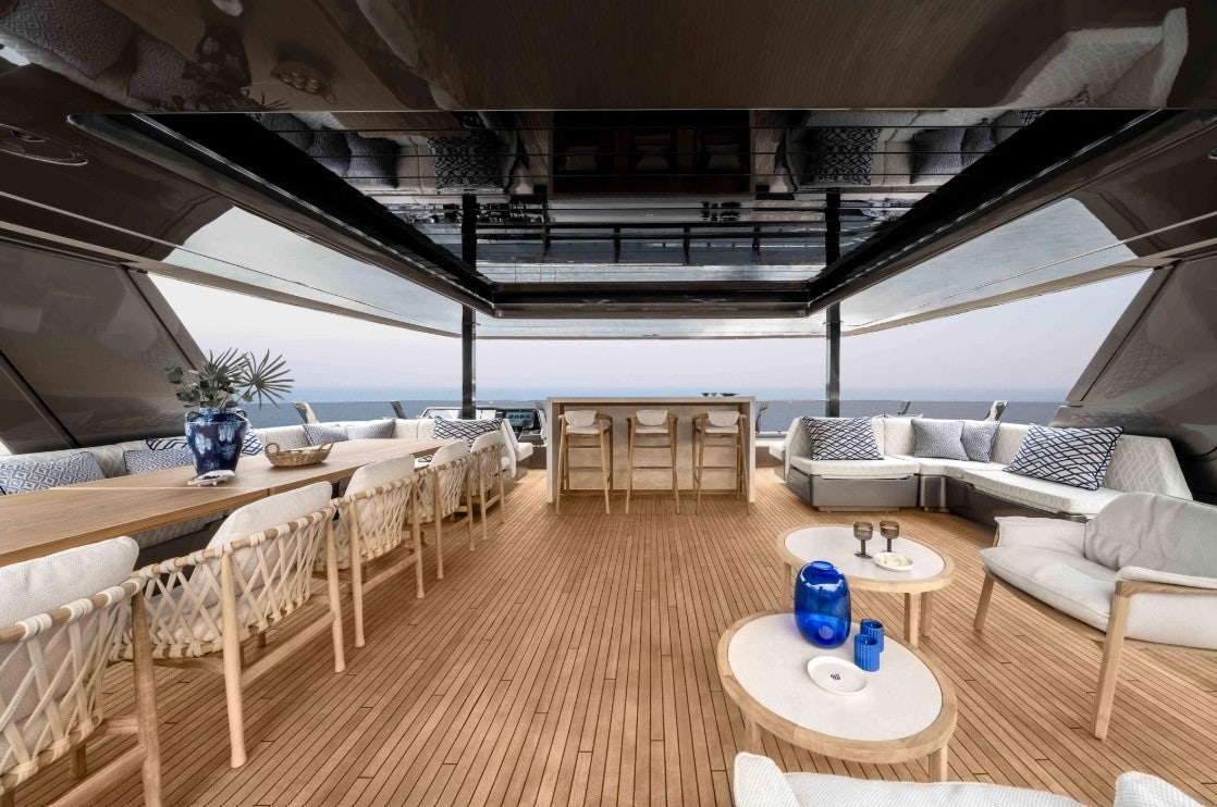 a room with a table chairs and a couch aboard AMITATU Yacht for Charter