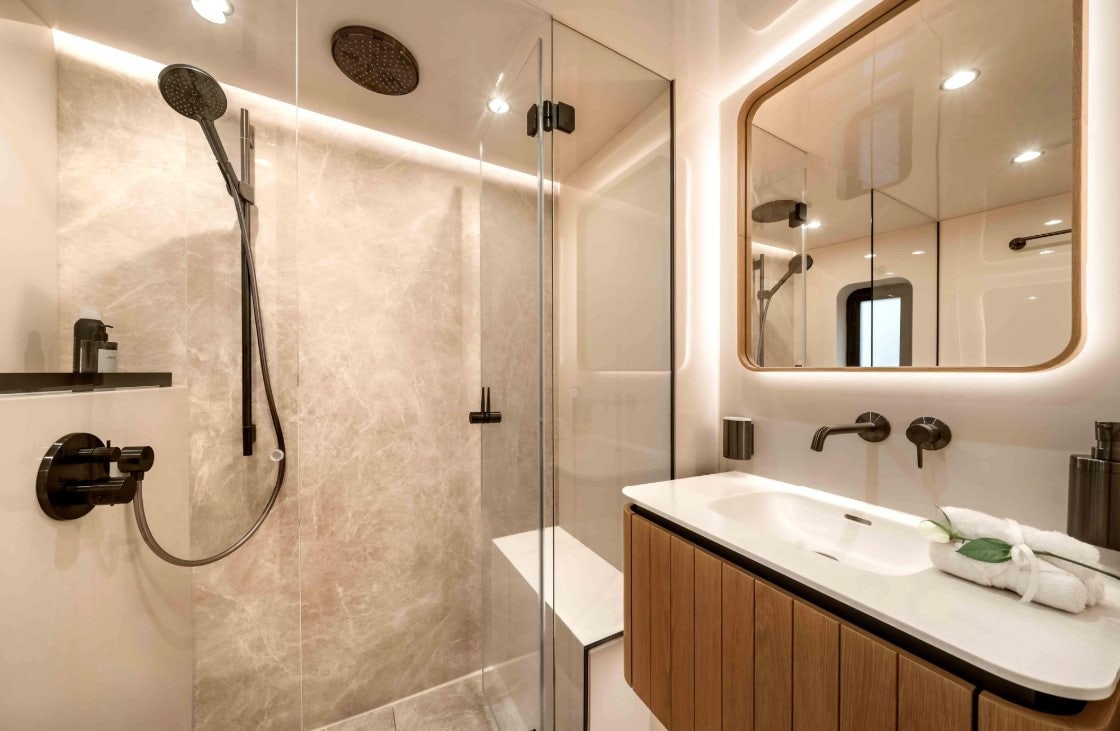 a bathroom with a shower and sink aboard AMITATU Yacht for Charter
