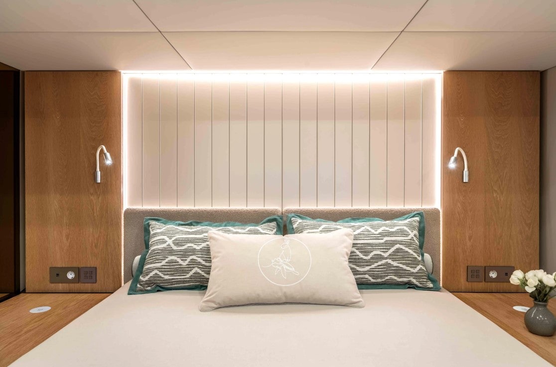 a bed with pillows aboard AMITATU Yacht for Charter