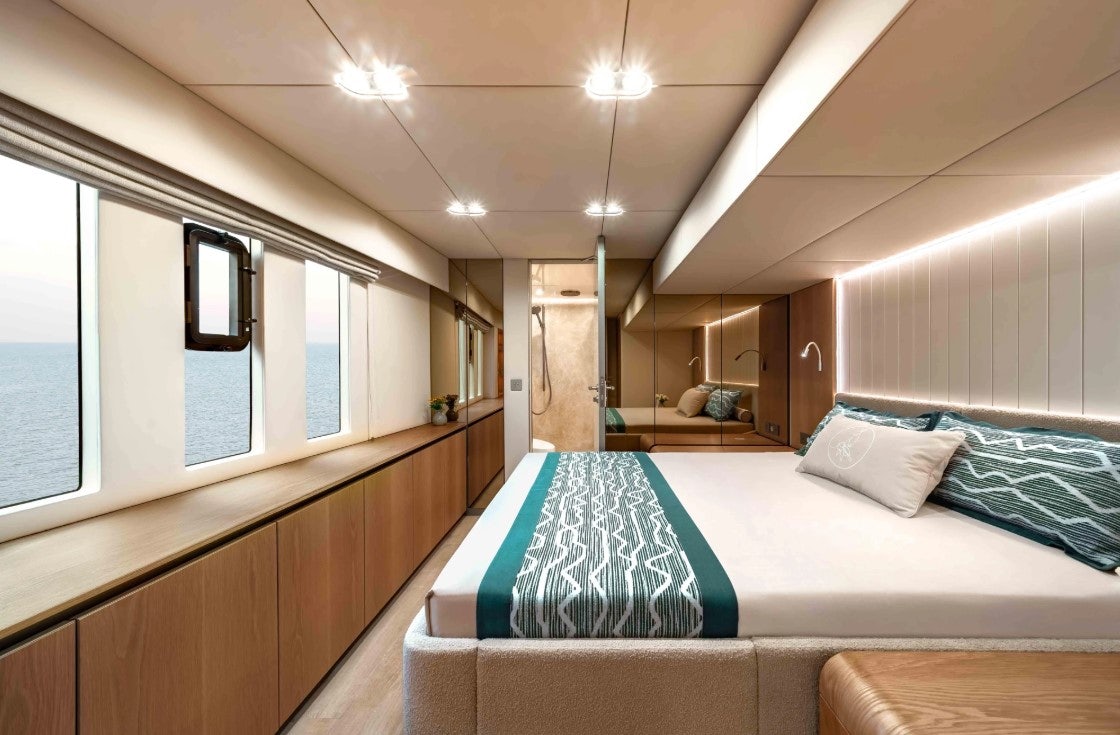 a room with a bed and a desk aboard AMITATU Yacht for Charter