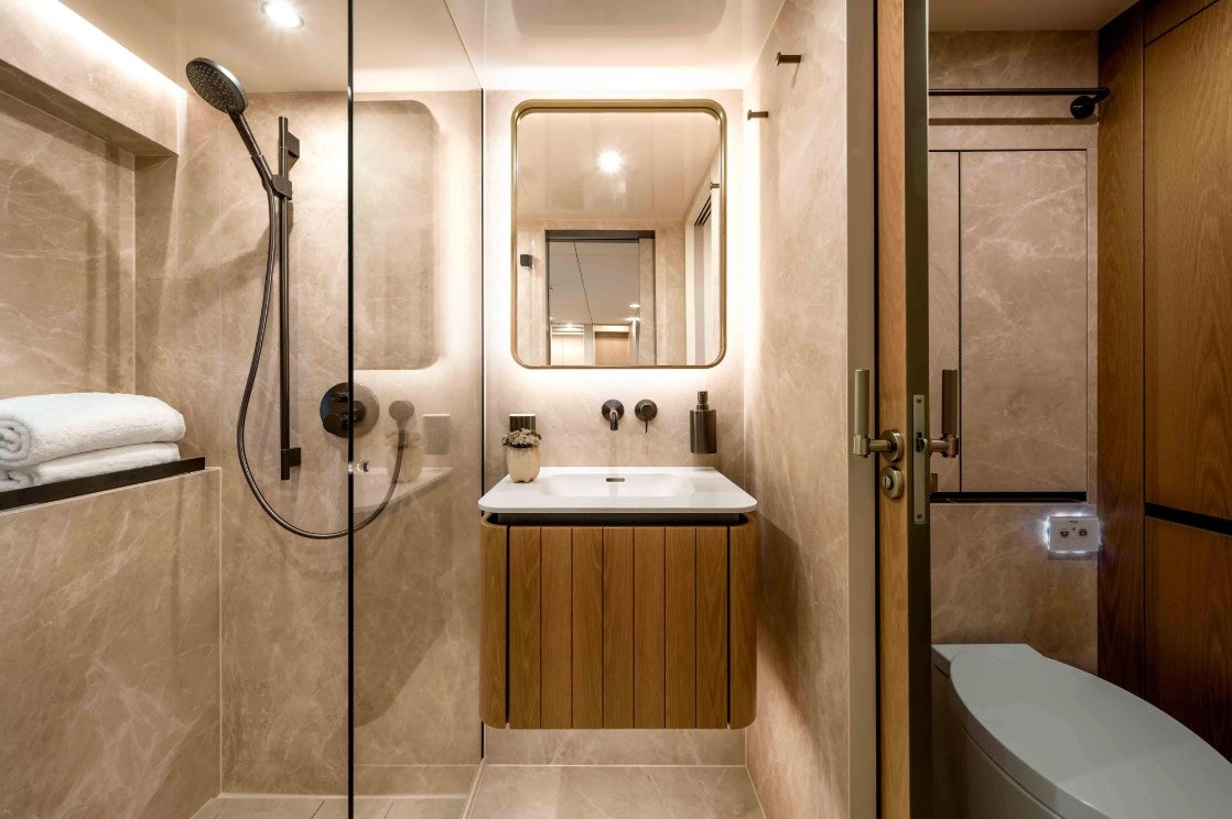 a bathroom with a sink and a shower aboard AMITATU Yacht for Charter