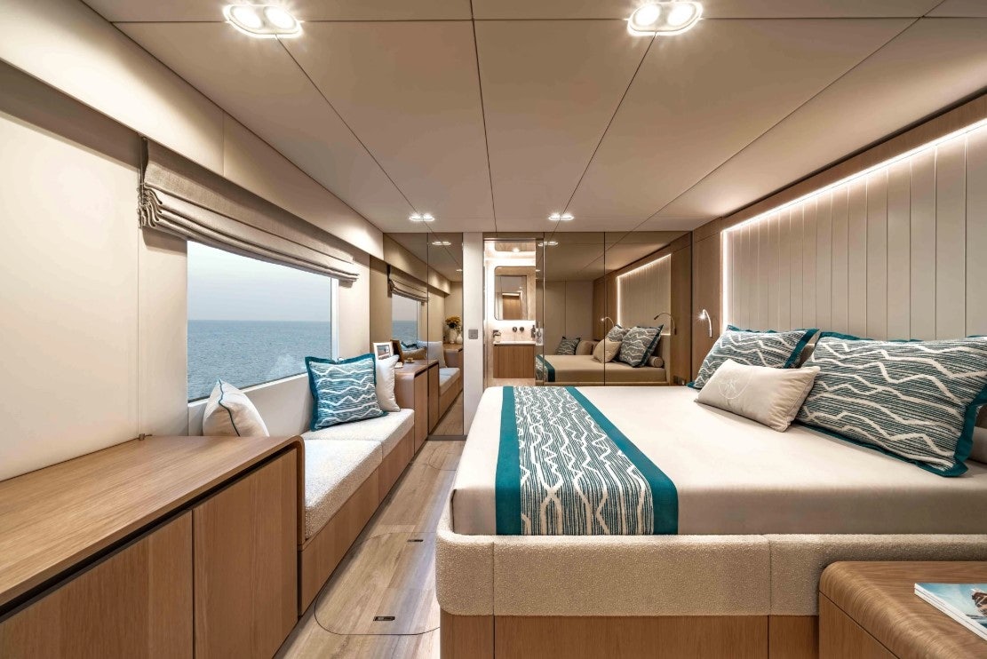 a room with a bed and a window aboard AMITATU Yacht for Charter