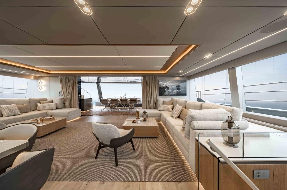 a living room with a large window aboard AMITATU Yacht for Charter