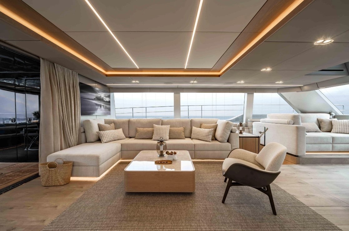 a living room with a large window aboard AMITATU Yacht for Charter