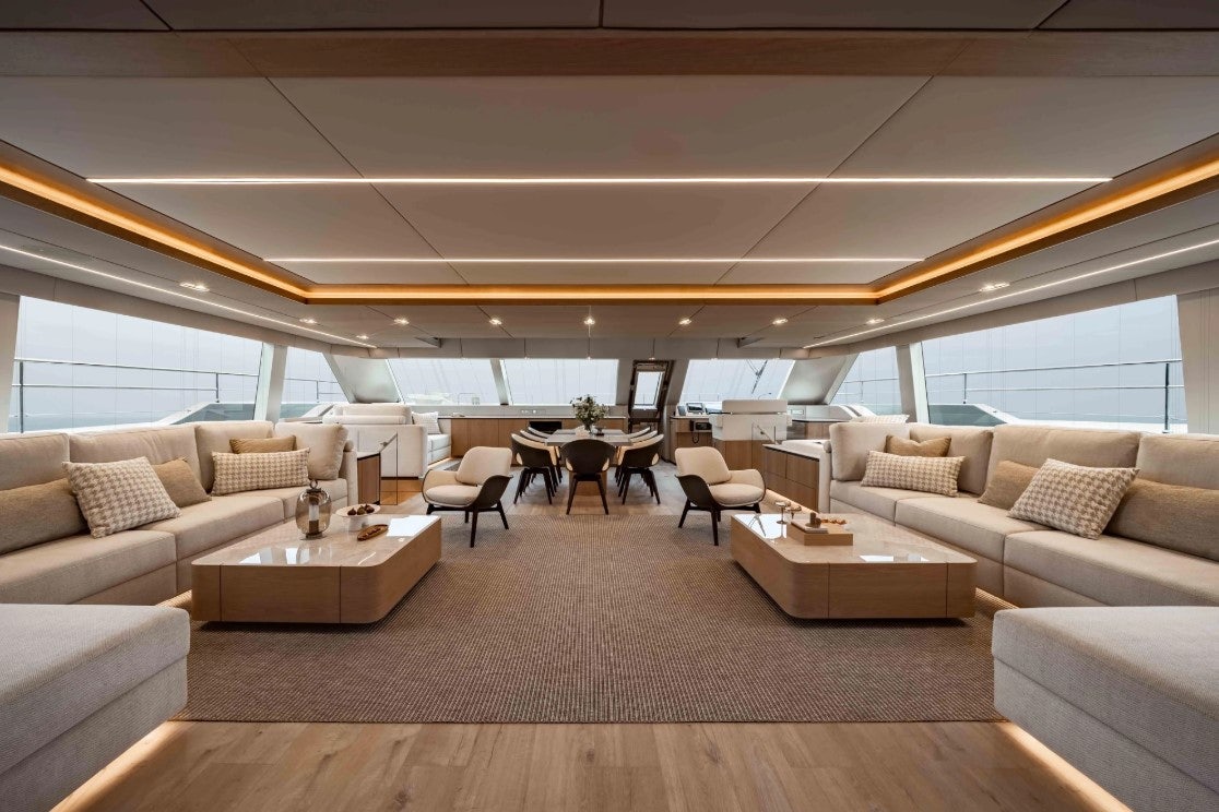 a living room with a couch and a table aboard AMITATU Yacht for Charter