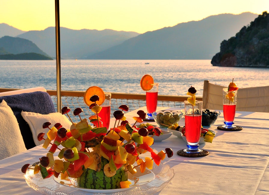 a table with food and drinks on it aboard BLUE LADY Yacht for Sale