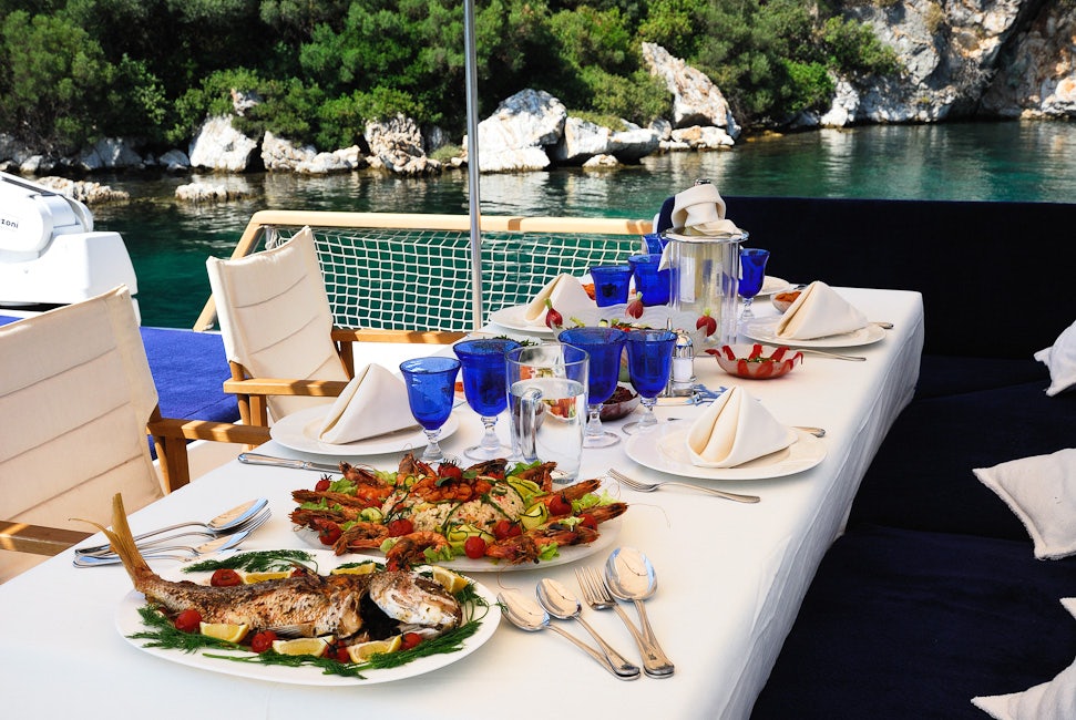 a table with food and drinks on it aboard BLUE LADY Yacht for Sale