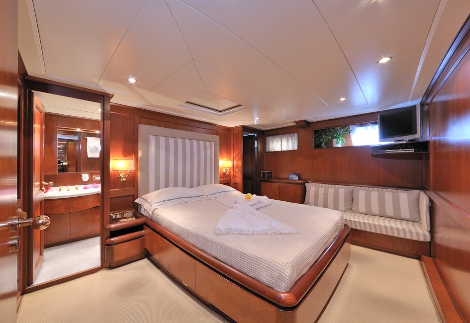 a room with a bed and a mirror aboard BLUE LADY Yacht for Sale