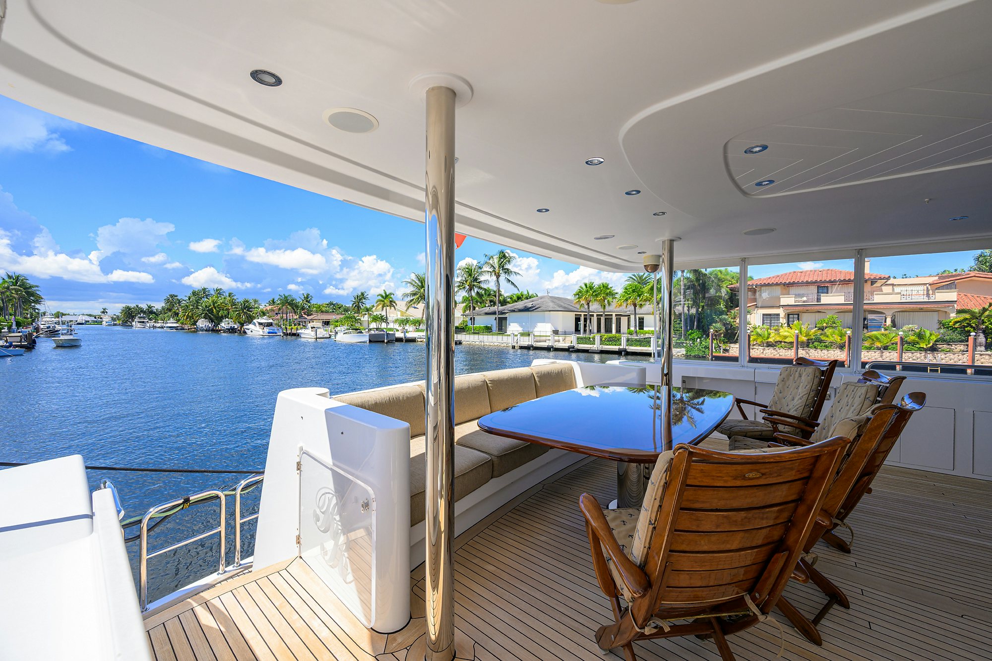 a deck with chairs and a body of water aboard REMY ROO Yacht for Sale