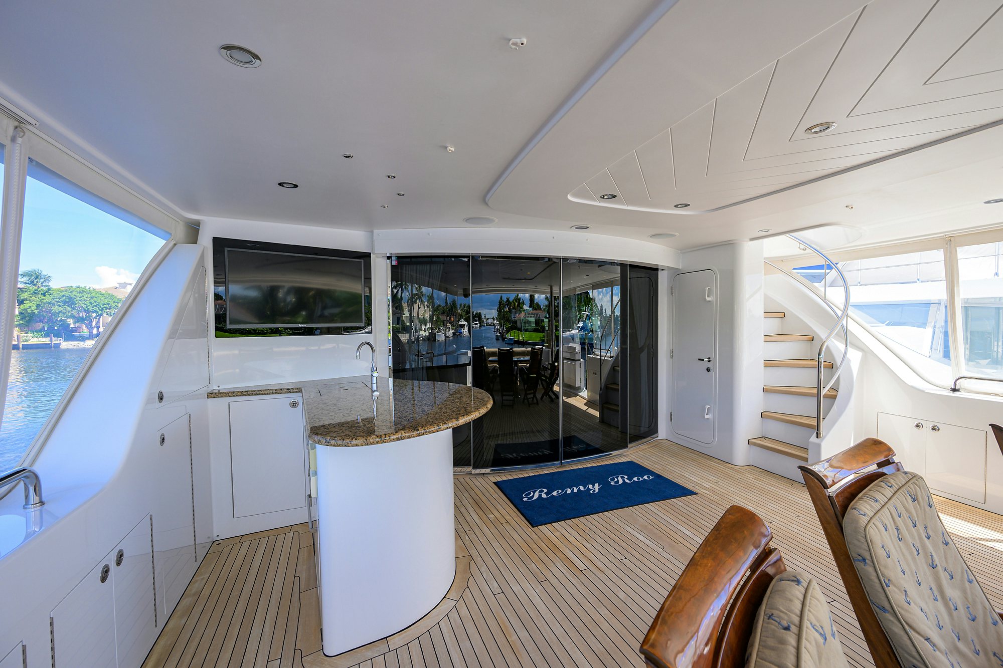 a large white room with a wood floor and a large window aboard REMY ROO Yacht for Sale