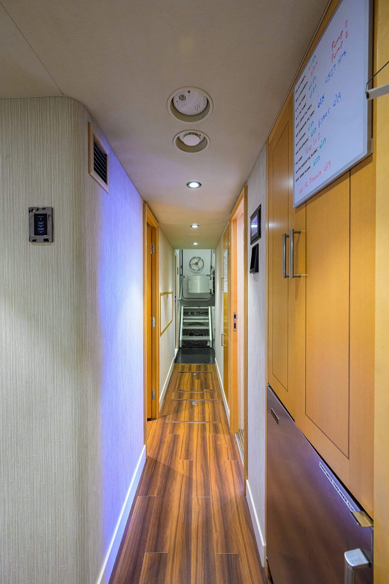 a hallway with a clock on the wall aboard REMY ROO Yacht for Sale