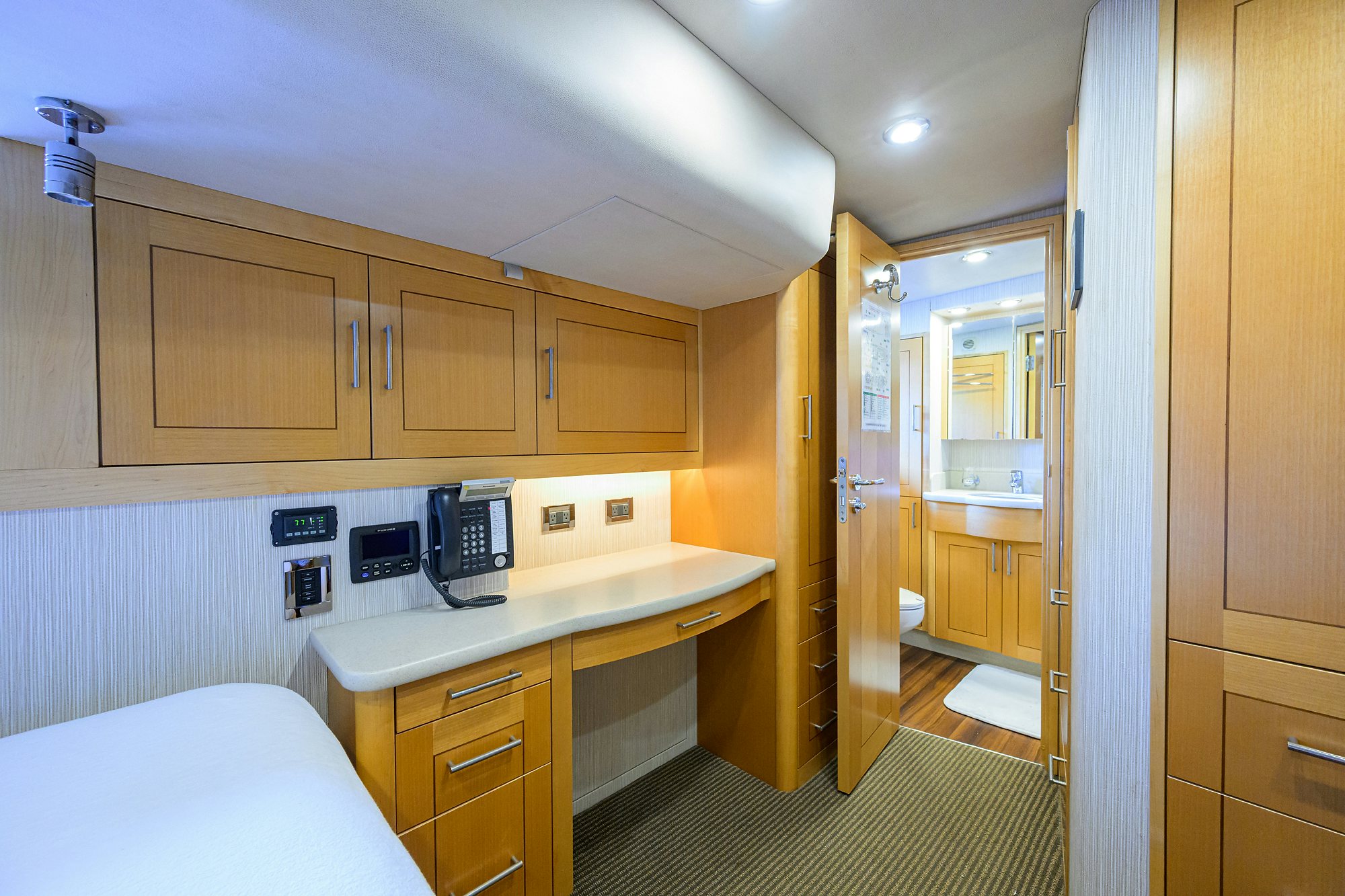 a bedroom with a bed and a sink aboard REMY ROO Yacht for Sale