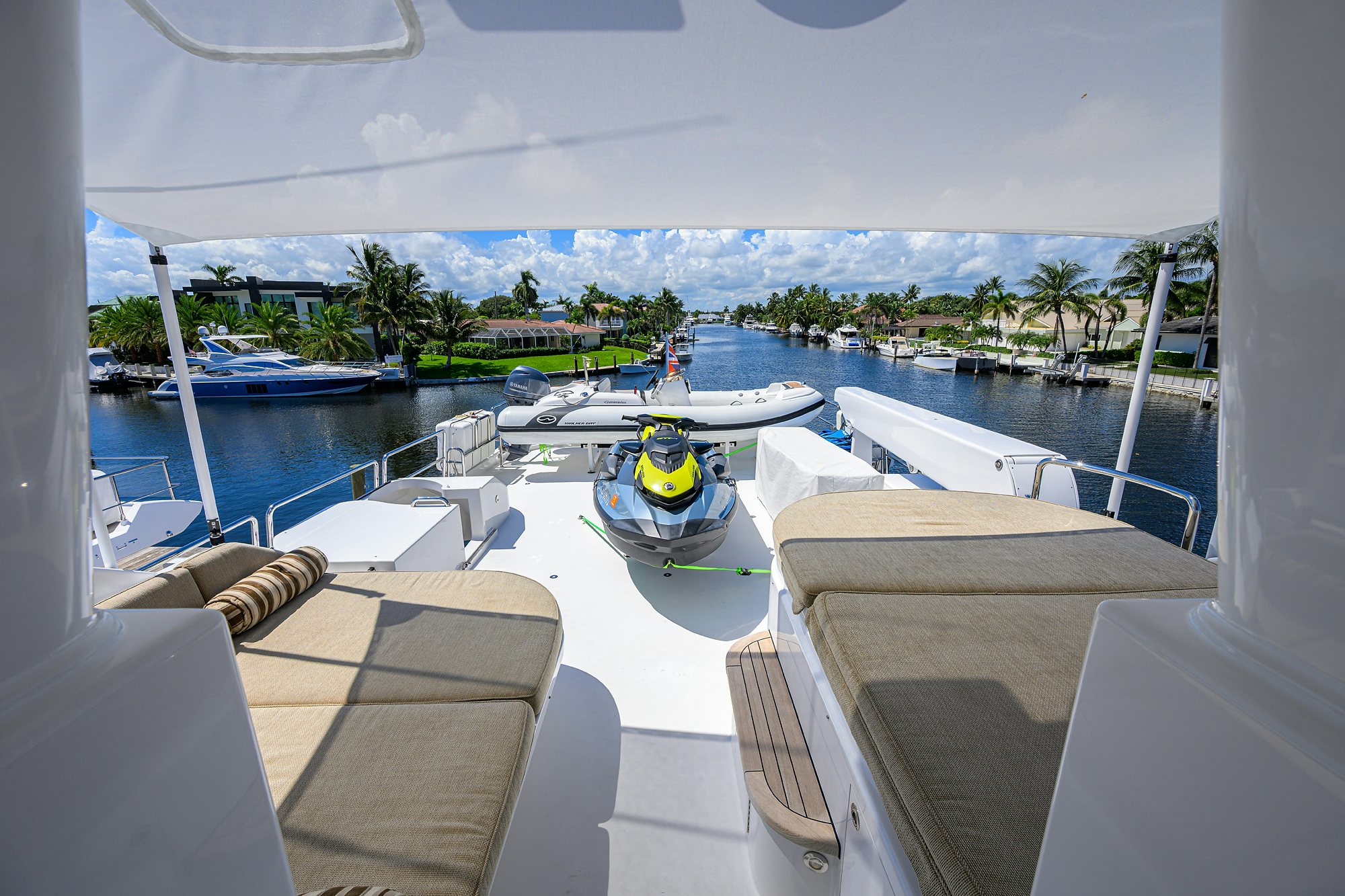 a view of a marina with boats and palm trees aboard REMY ROO Yacht for Sale