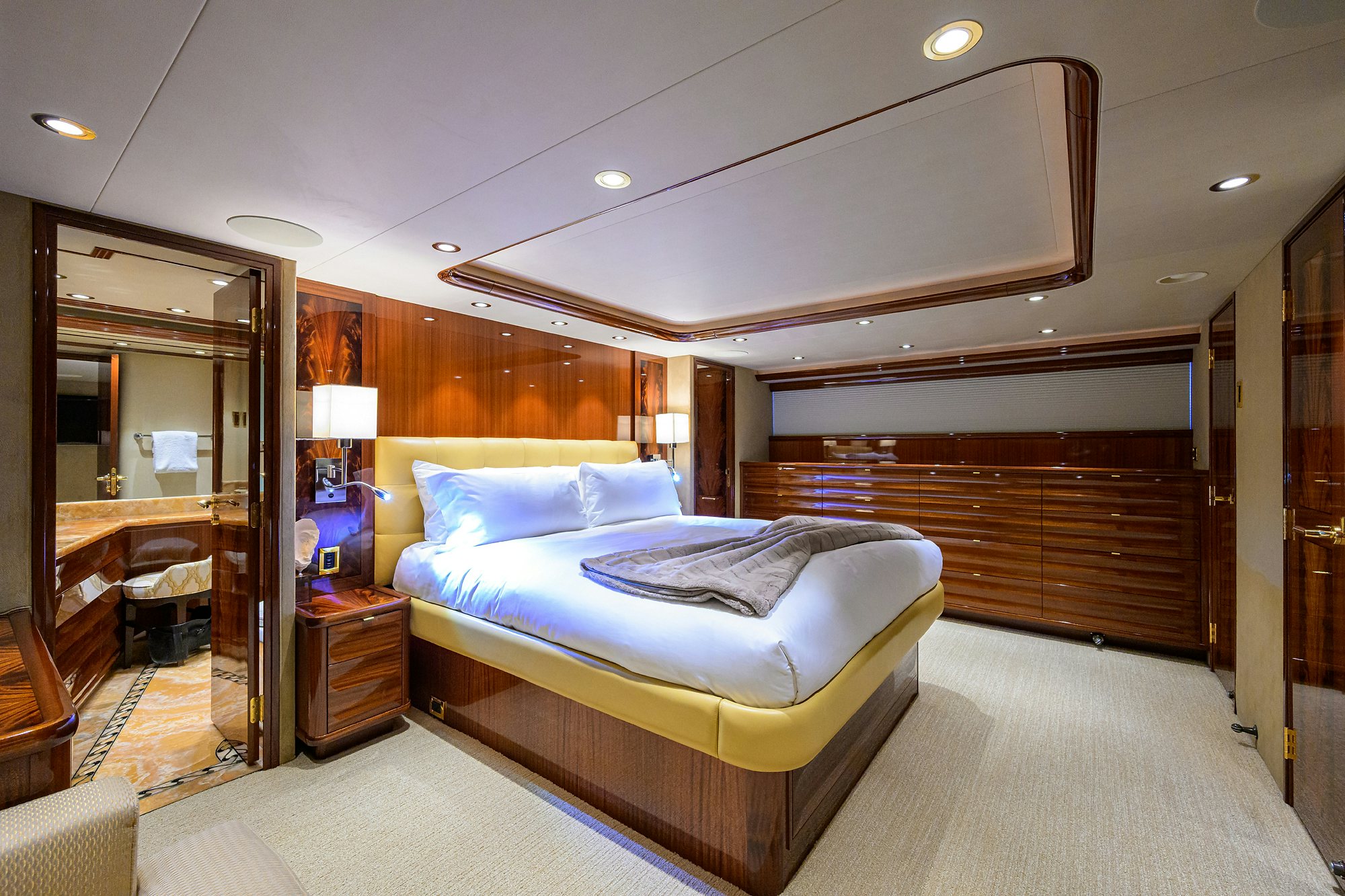a bedroom with a bed and a mirror aboard REMY ROO Yacht for Sale
