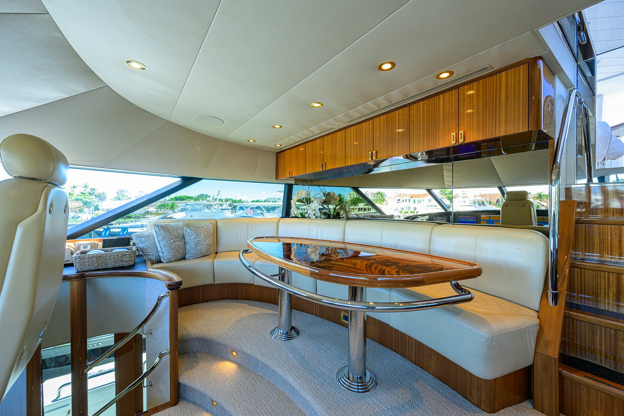 a living room with a large glass table and a large window aboard REMY ROO Yacht for Sale