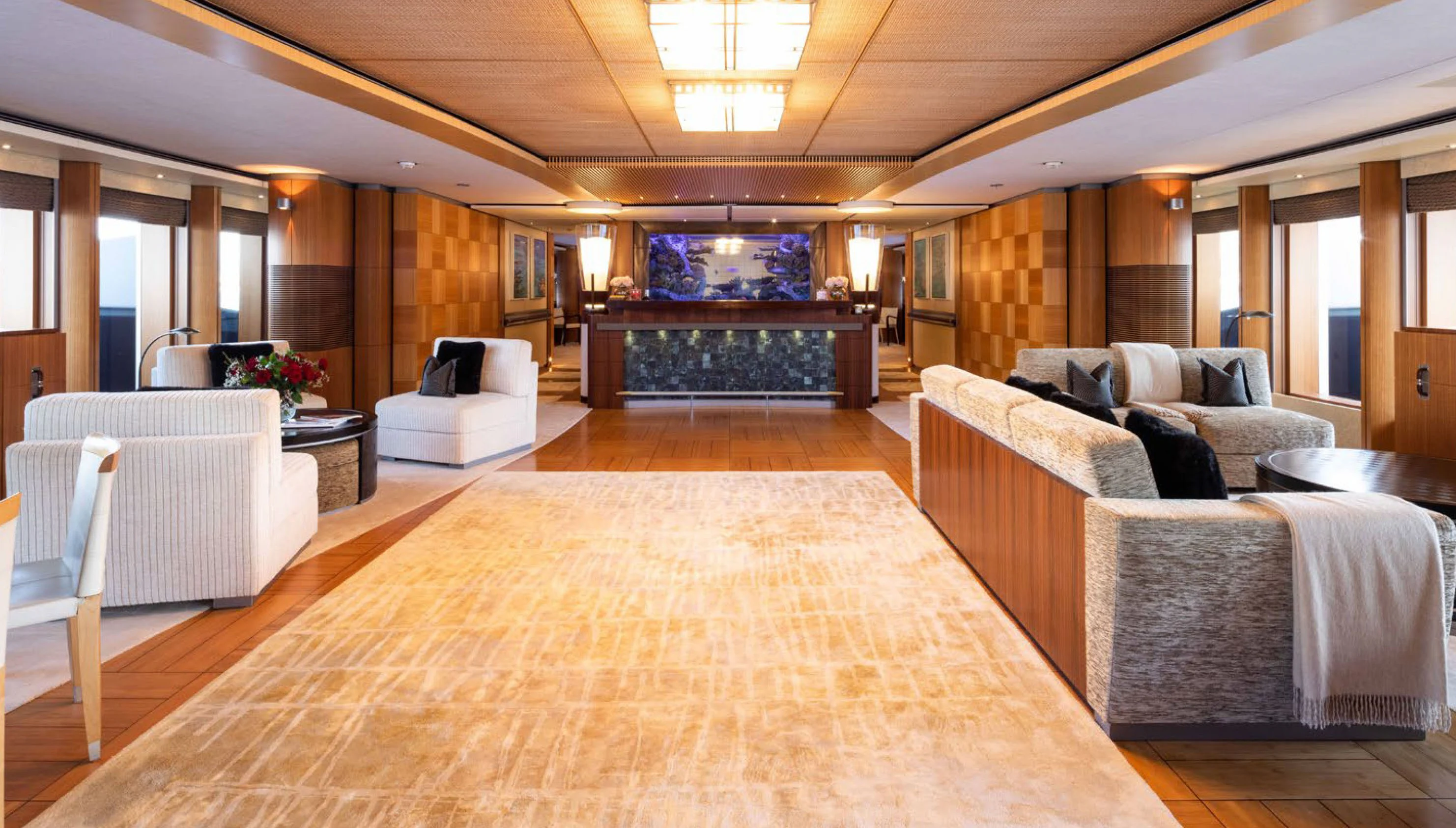 a large room with a couch and a table aboard WHEELS Yacht for Charter
