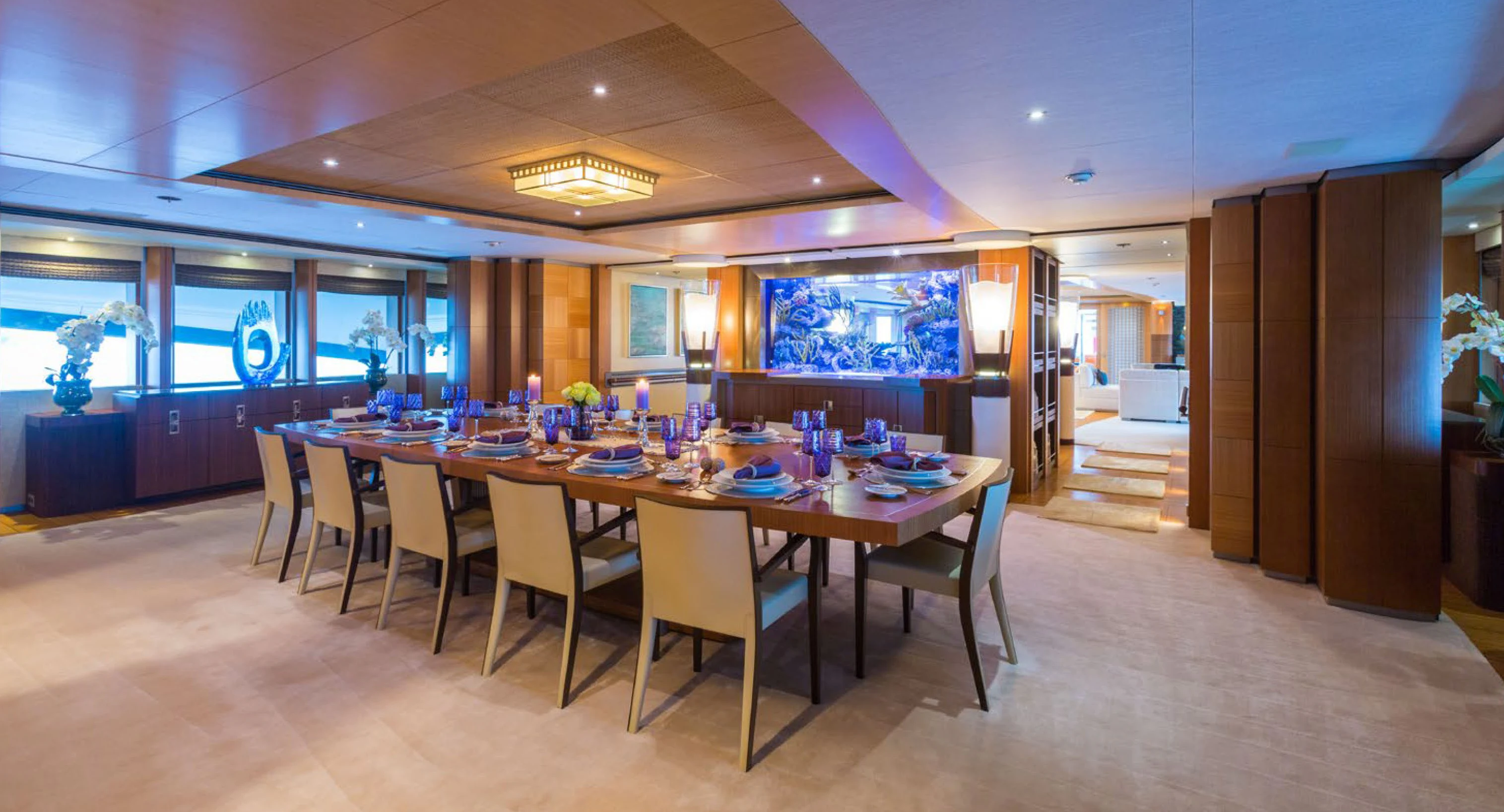 a large room with a table and chairs aboard WHEELS Yacht for Charter
