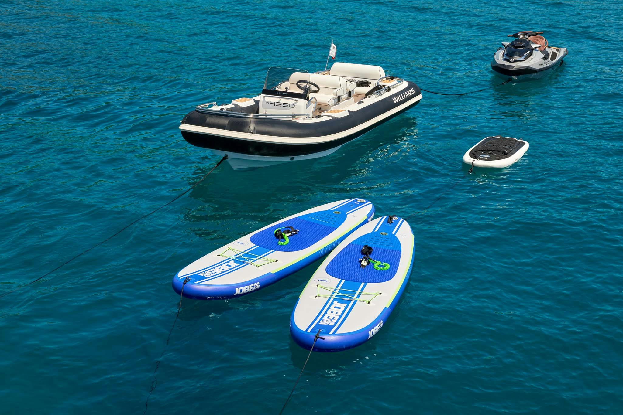 a group of boats in the water aboard HEED Yacht for Charter