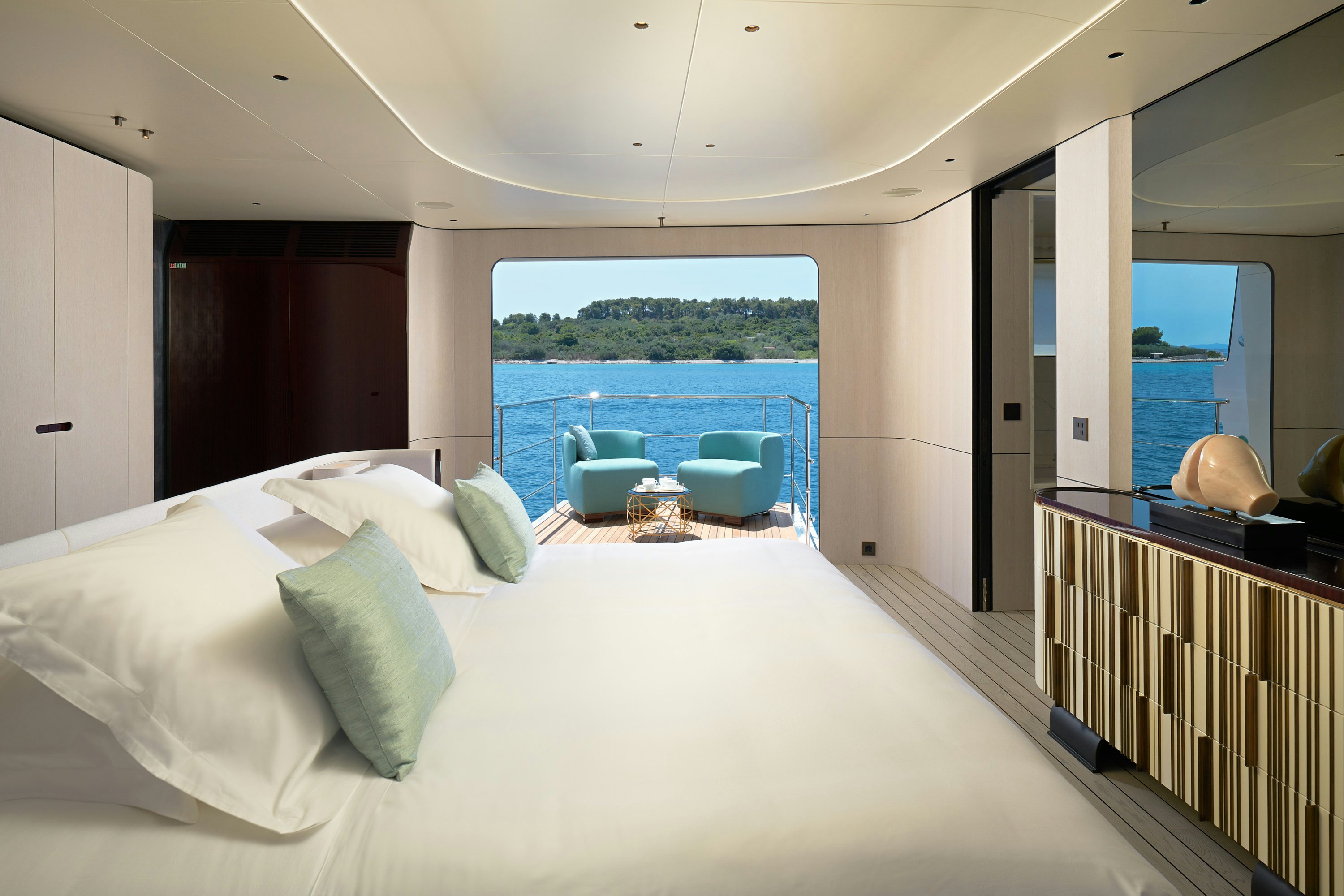a bed with white sheets and pillows aboard HEED Yacht for Sale