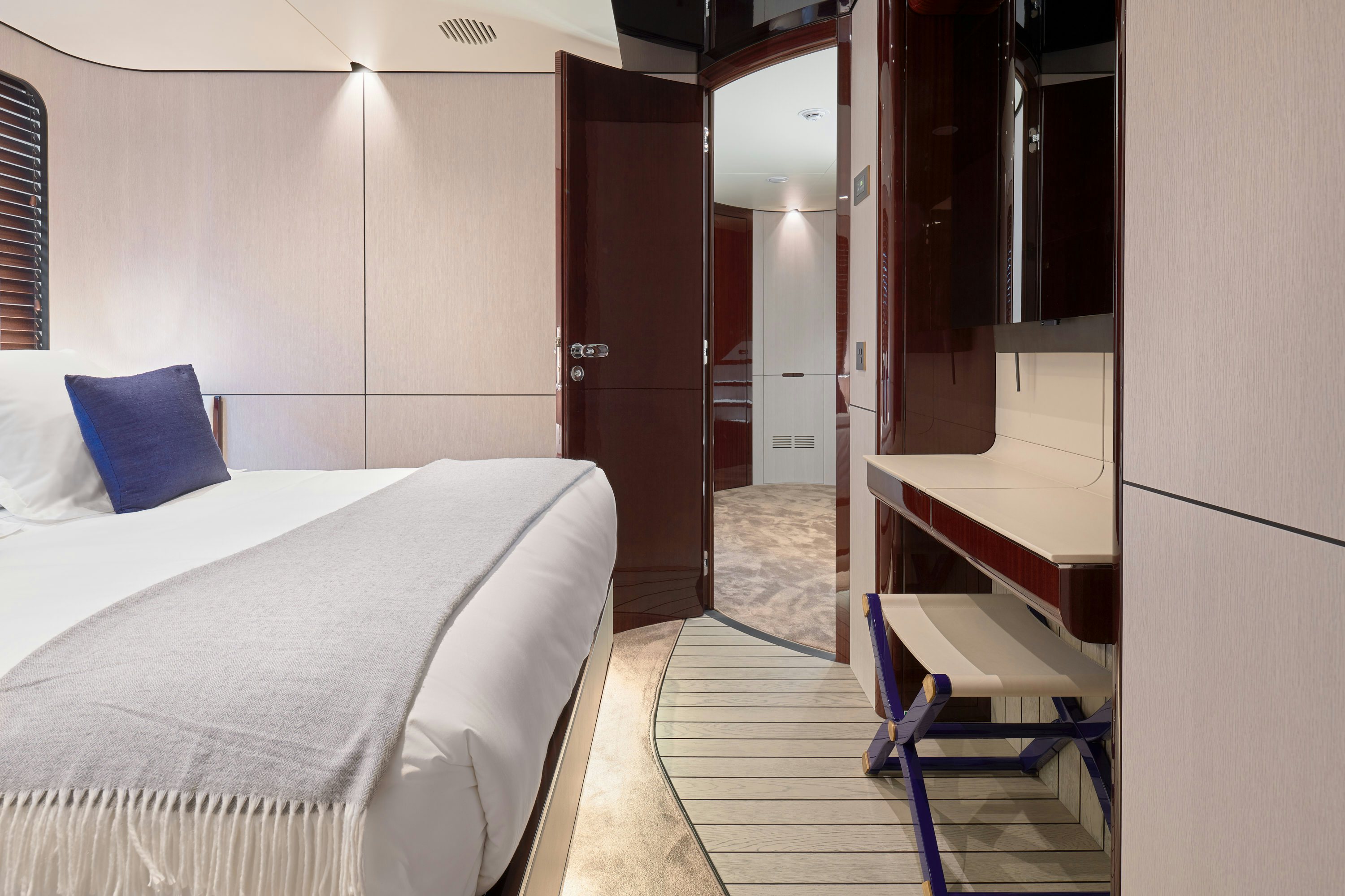 a room with a bed and desk aboard HEED Yacht for Sale