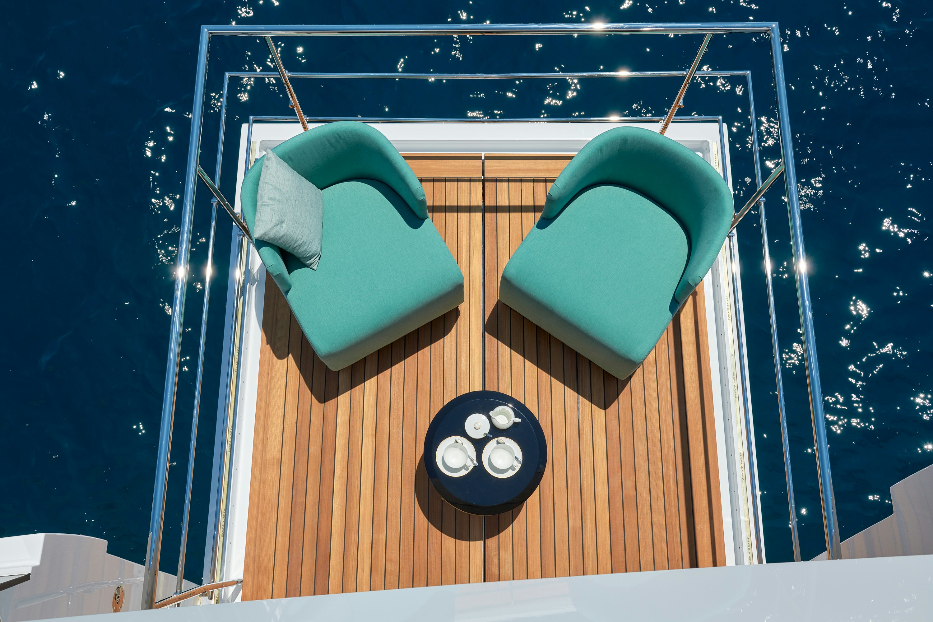 a green and black object with a green rectangle on a wooden surface aboard HEED Yacht for Sale