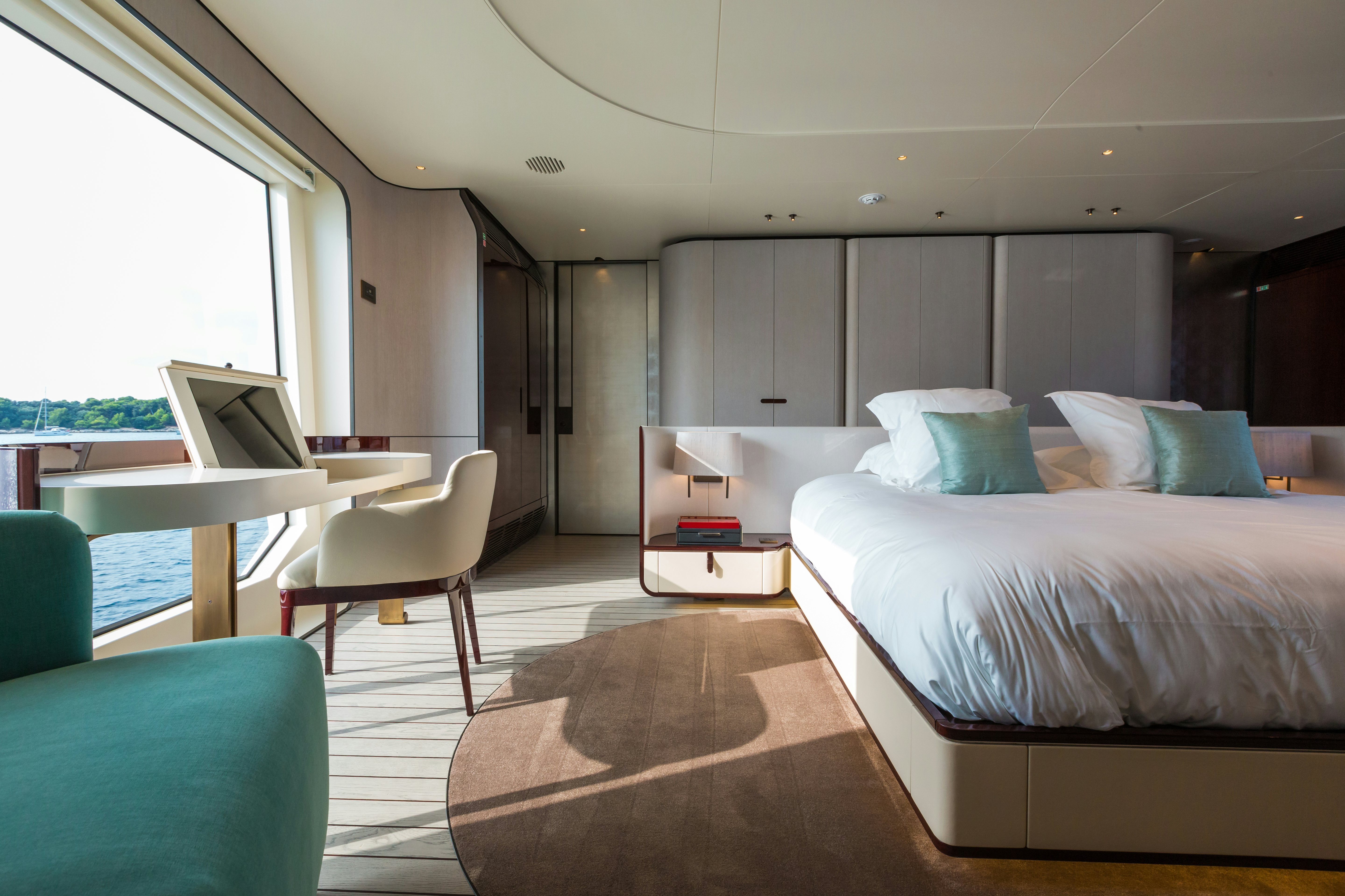 a room with a bed and a desk aboard HEED Yacht for Sale