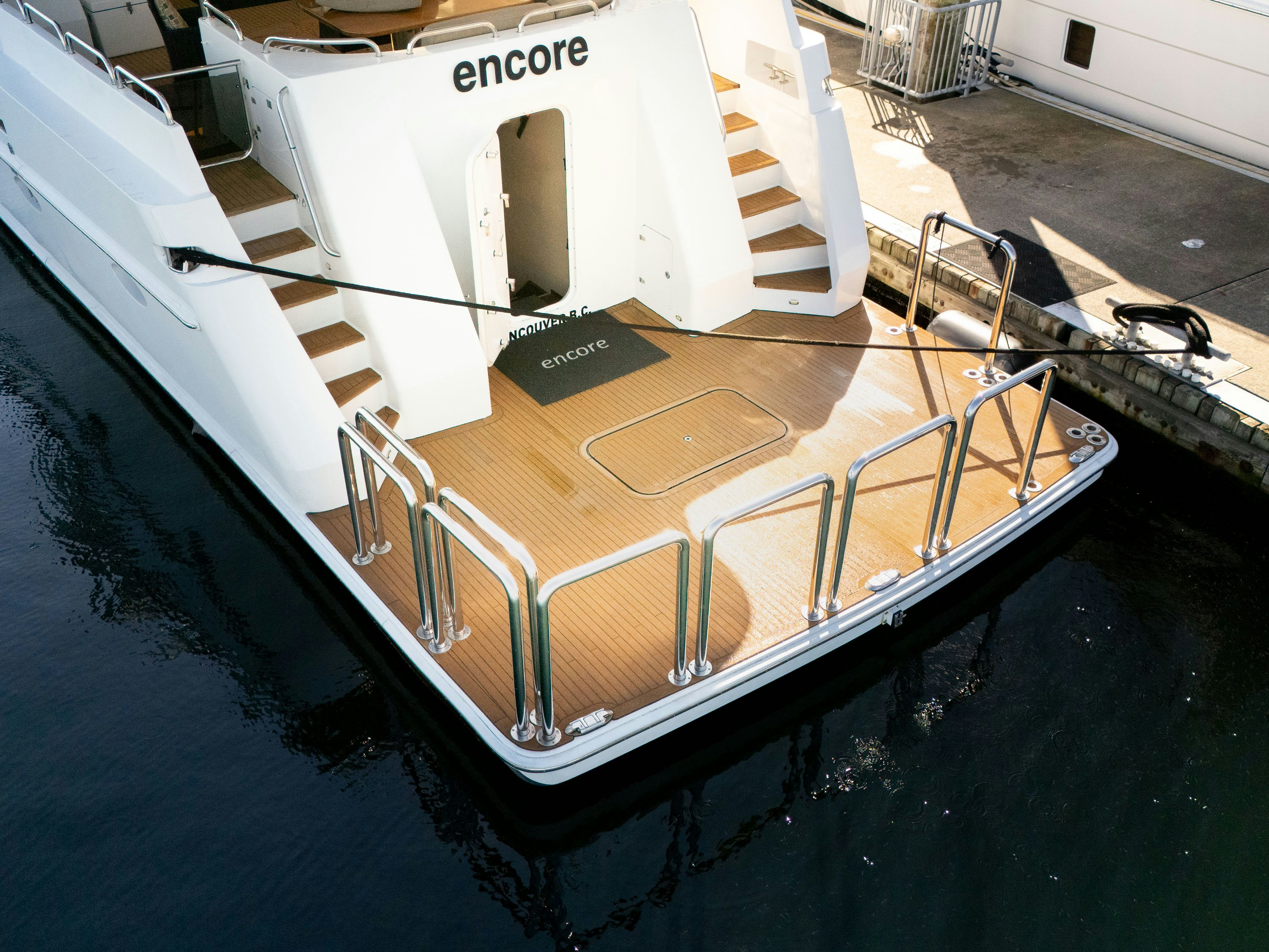 a large white boat on a body of water aboard ENCORE Yacht for Sale