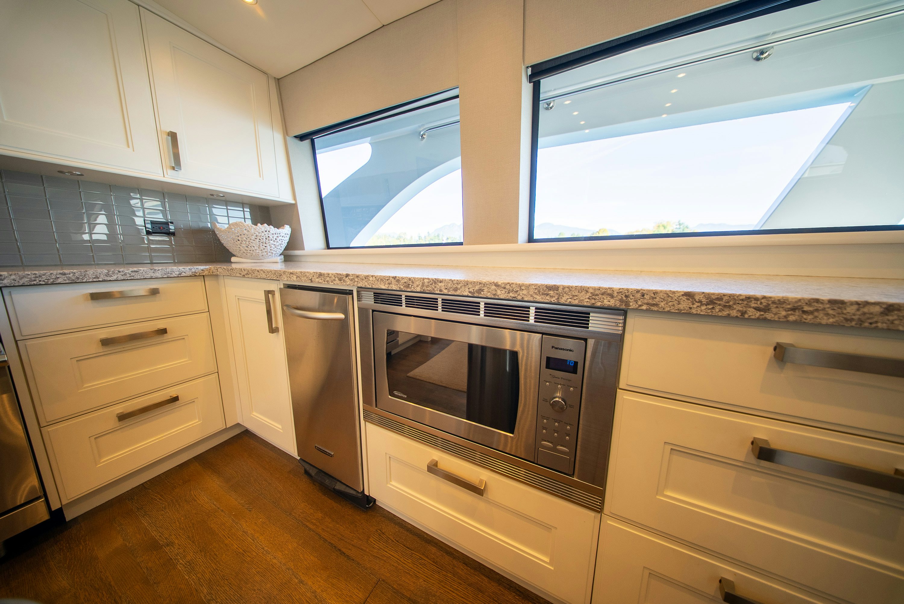 a kitchen with white cabinets aboard ENCORE Yacht for Sale