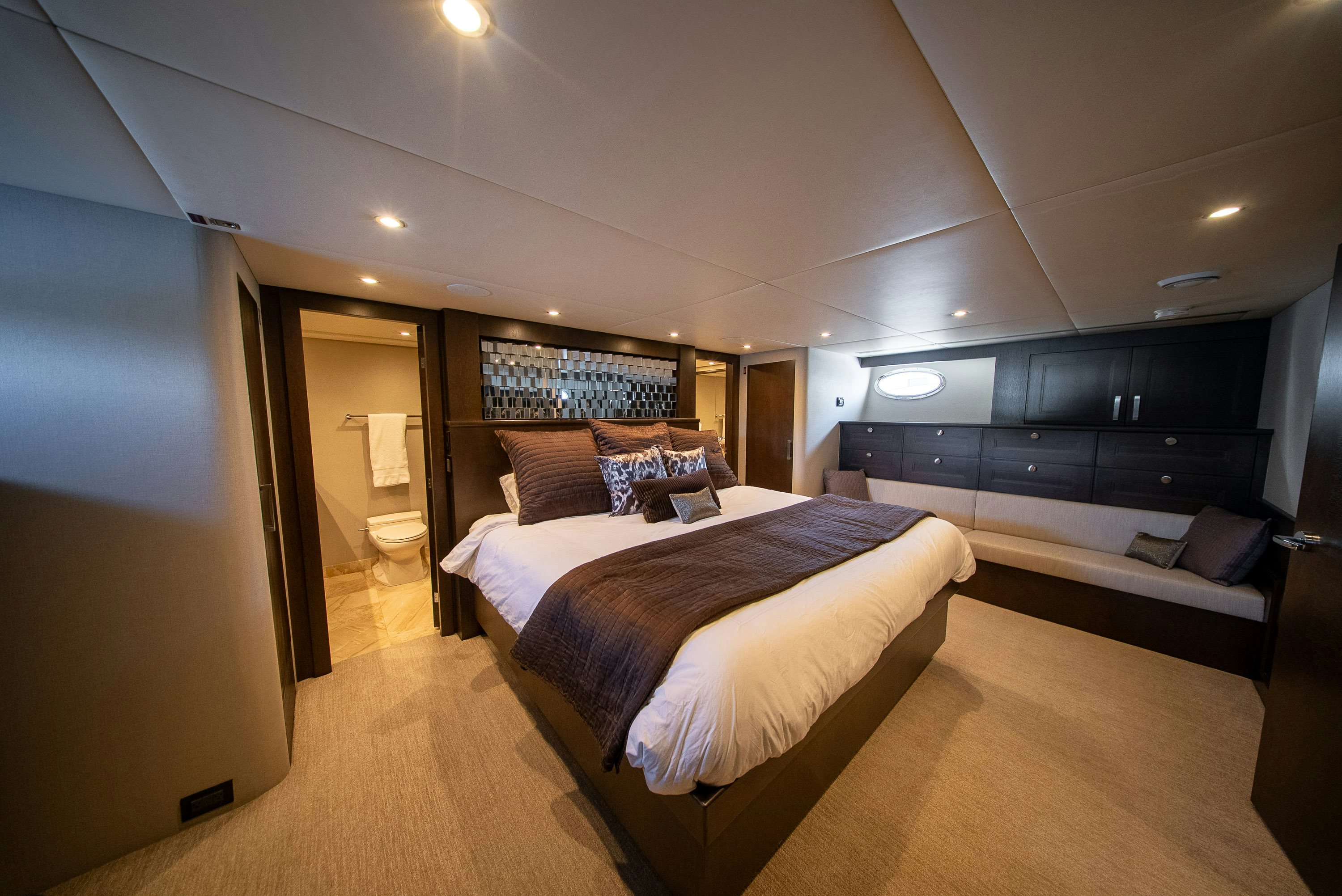 a room with a bed and a couch aboard ENCORE Yacht for Sale